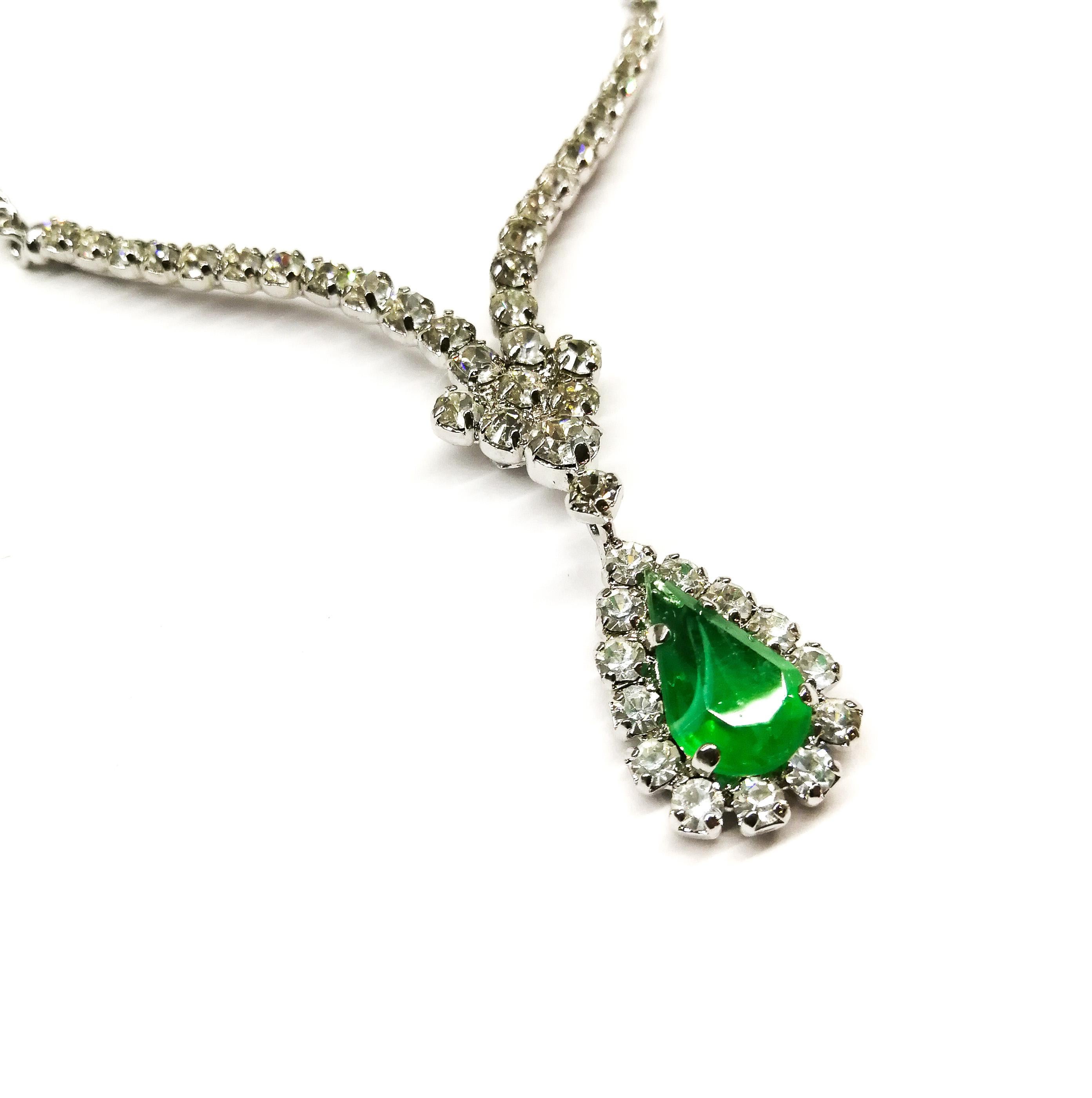 A charming and delicate drop necklace made by Henkel and Grosse for Christian Dior in the 1970s. A very fine chain, with a clasp that can be varied in length to suit the wearer, continues to a V shaped clear paste pendant with a beautiful 'emerald'