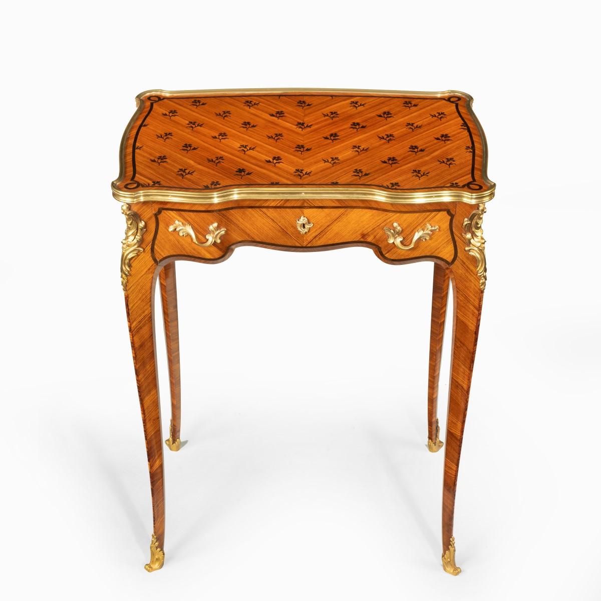 A delicate Napoleon III kingwood parquetry side table attributed to Sormani, the shaped serpentine top with a single frieze drawer above tapering cabriole legs, decorated with inlaid ebony florets on a herringbone ground and fine quality ormolu