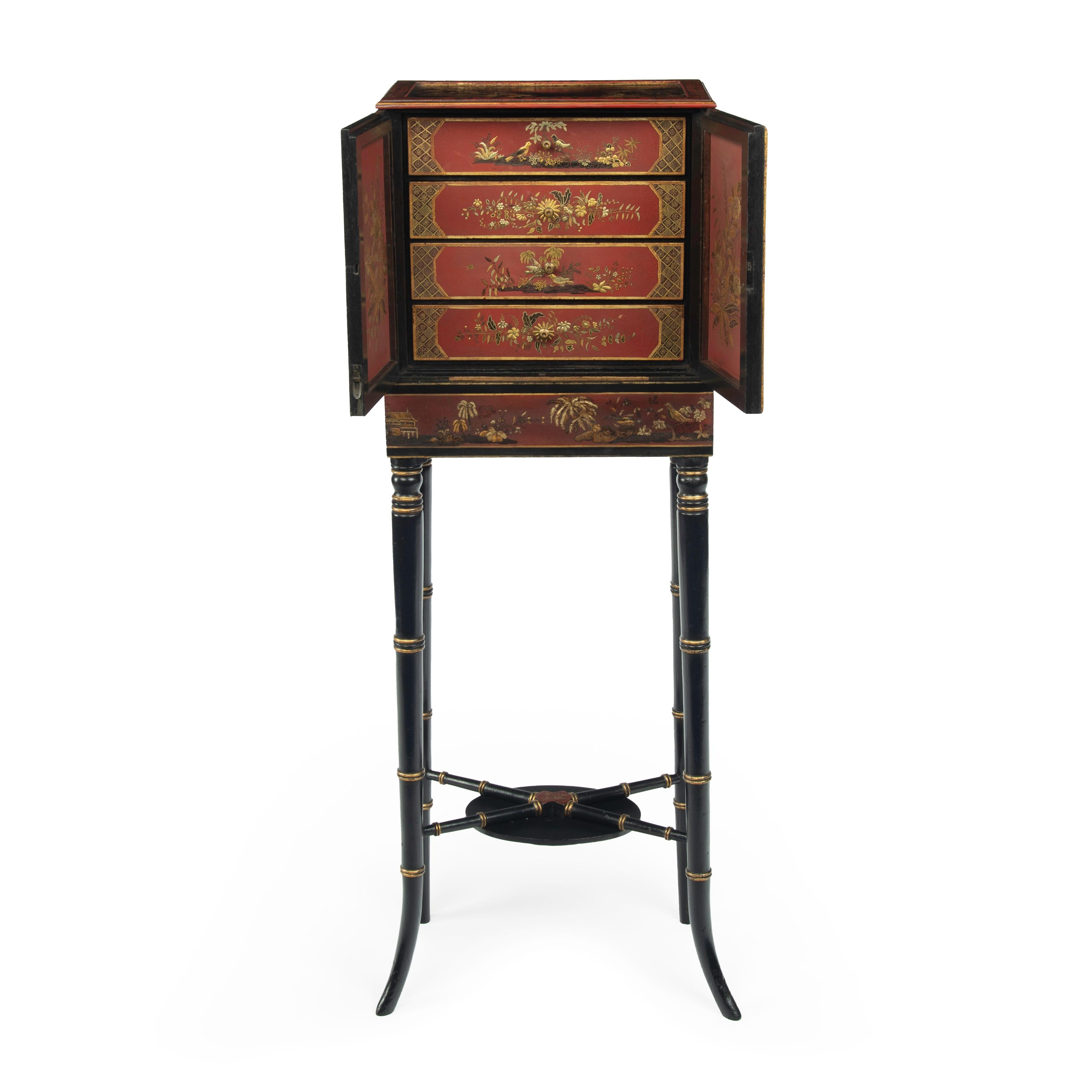 A delicate Regency Chinoiserie lacquer cabinet, of rectangular form with two doors opening to reveal four small drawers, decorated throughout in gilt, black and cinnabar lacquer, the top, doors and sides with figures in landscapes including a picnic