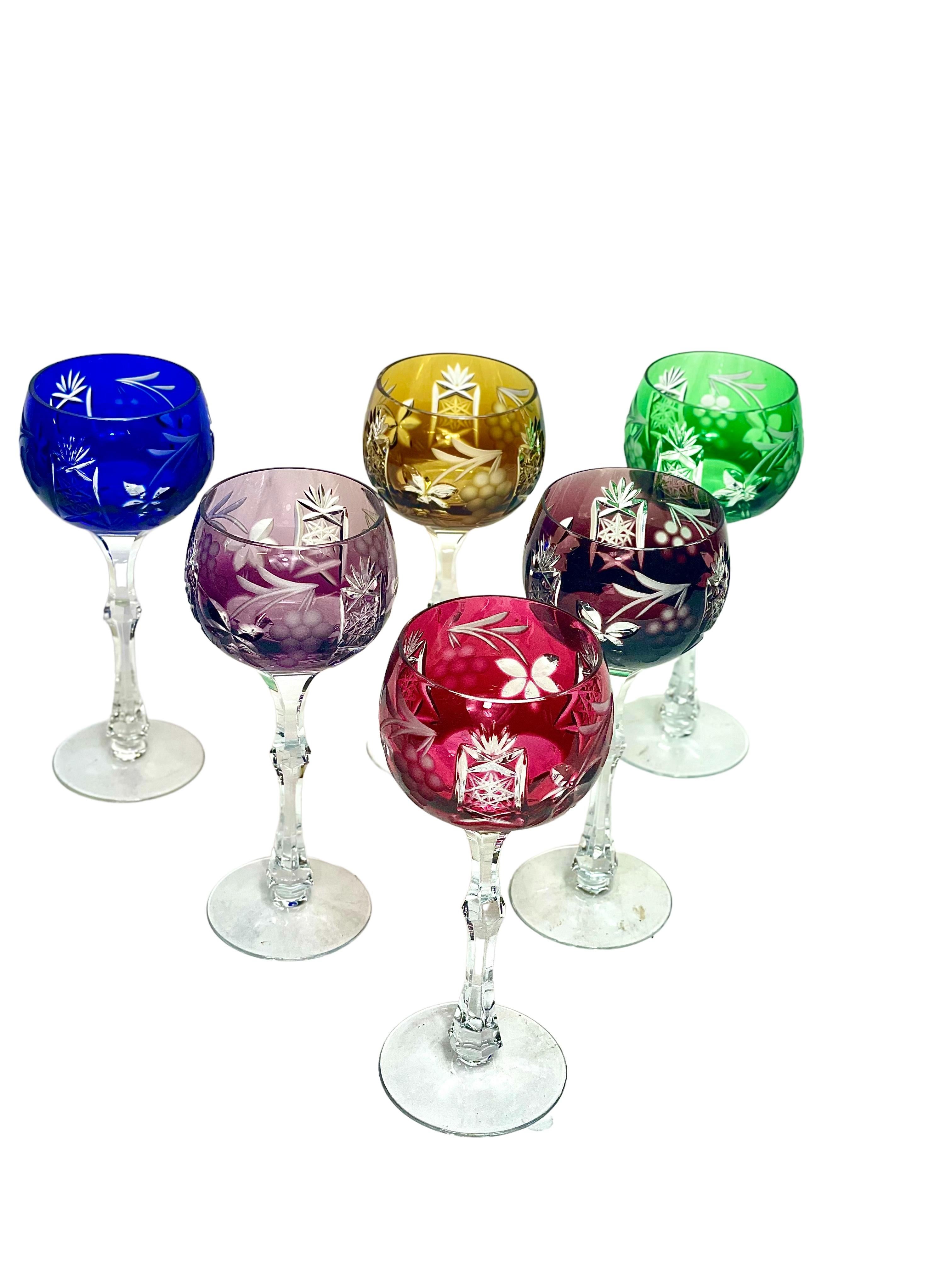 This sparkling set of six crystal Rhine (or white) wine glasses in an array of six vibrant colours features a delicate, hand-cut design of grape vines and stylised leaves. Each cut-to-clear crystal glass has a cut and faceted stem, with a simple