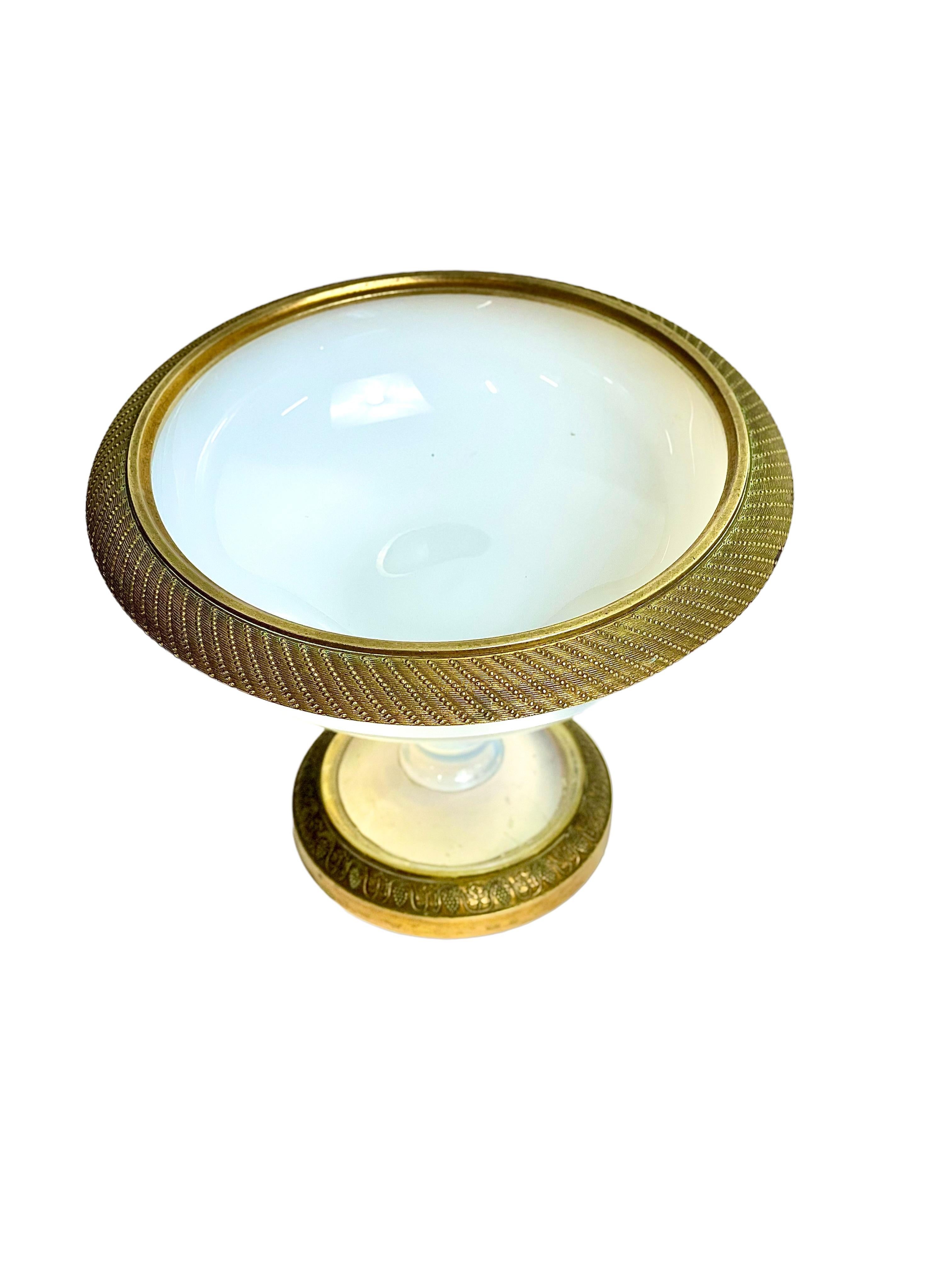 A stunning white opaline 'Bulle de Savon' pedestal bowl, with gilt bronze rim and edging. This magnificent Charles X period glass bowl is manufactured from delicate opaline, a decorative style of glass made in France in the 19th century, and which