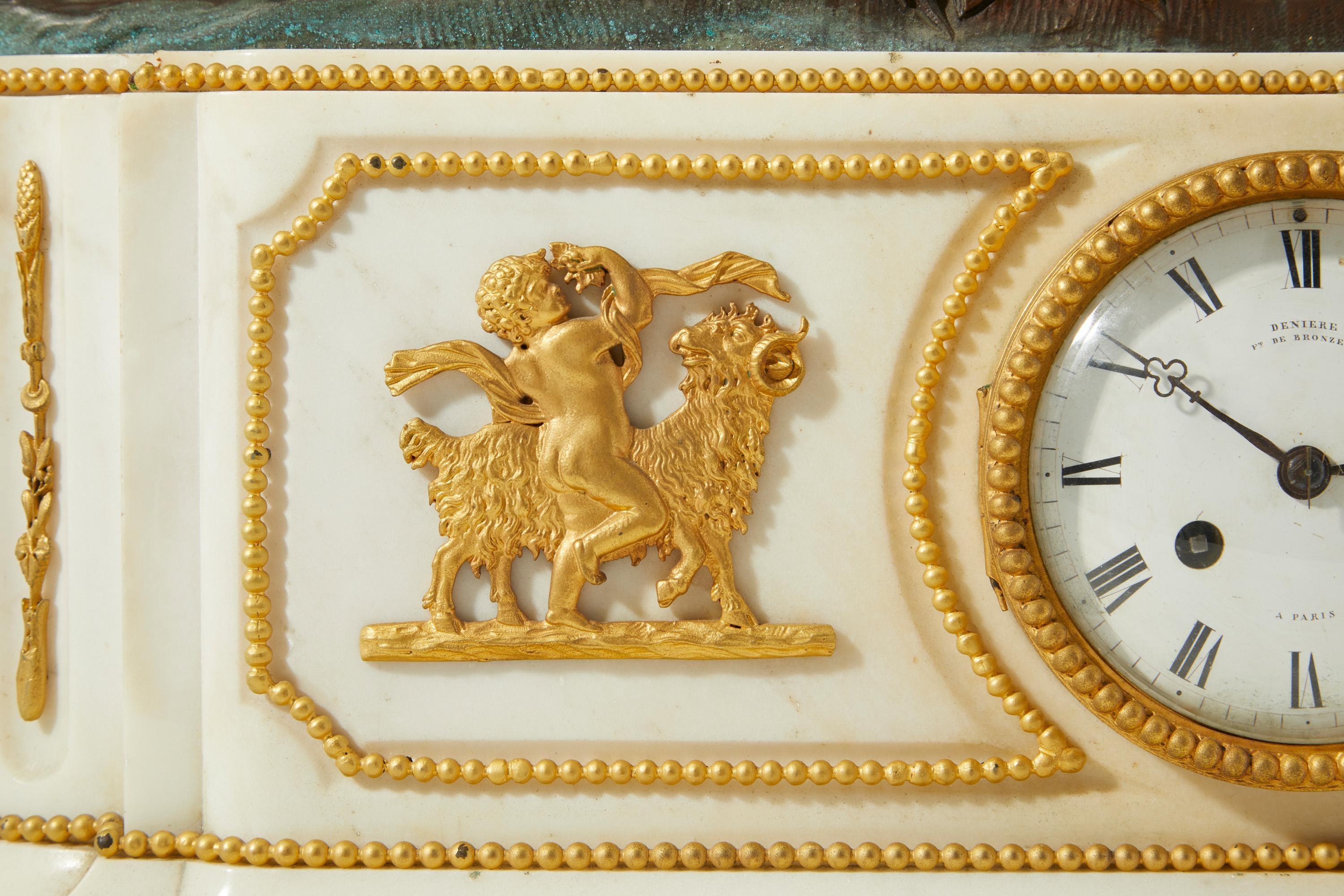 Deniere signed dial Comprising of a white marble and gilt bronze clock set and two putti candelabra.