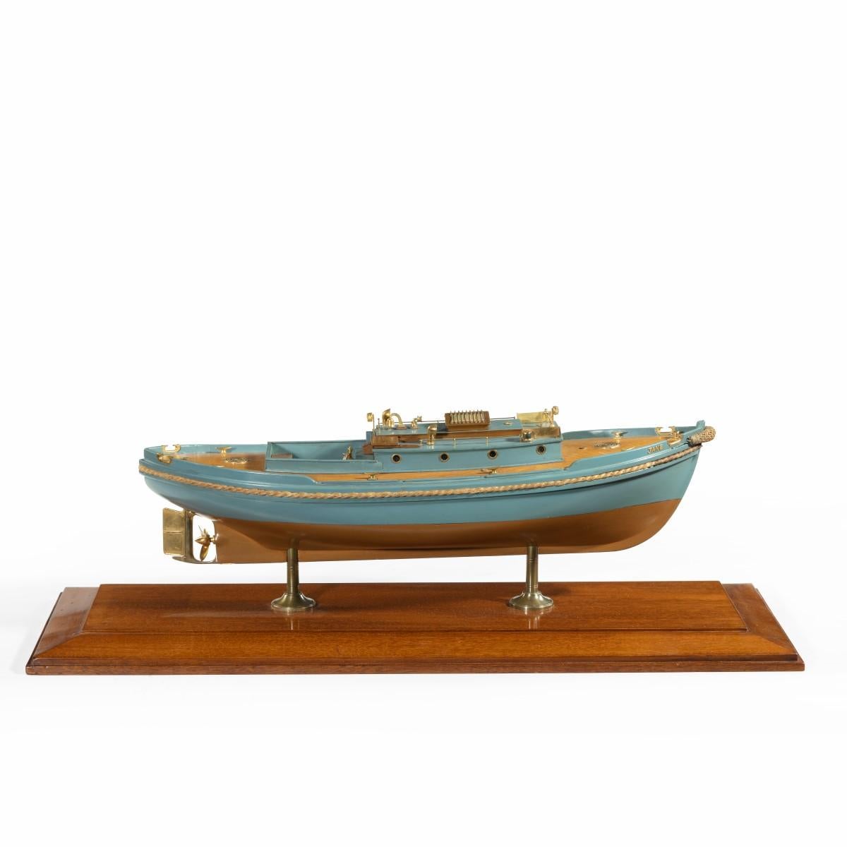 A detailed owner’s model or shipyard model of a double ended harbour launch, painted pale blue, the coach house with eight portholes, fitted with port and starboard lights and other details, with a continuous rope fender round the gunwale, all