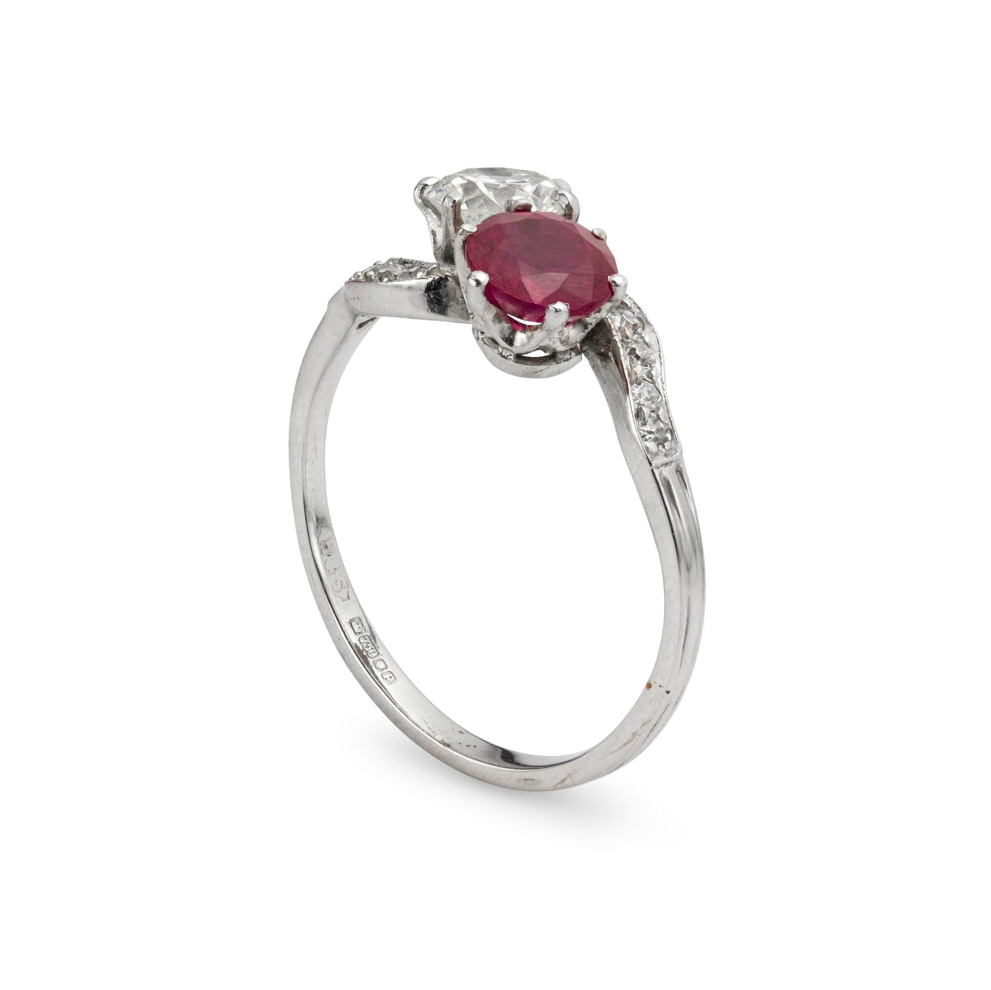 A diamond and ruby cross-over ring, the early brilliant-cut diamond, estimated to weigh 0.6 carats, and round faceted ruby, estimated to weigh 0.8 carats, claw set to the white mount with diamond set millegrain edge shoulders, later hallmarked 18ct