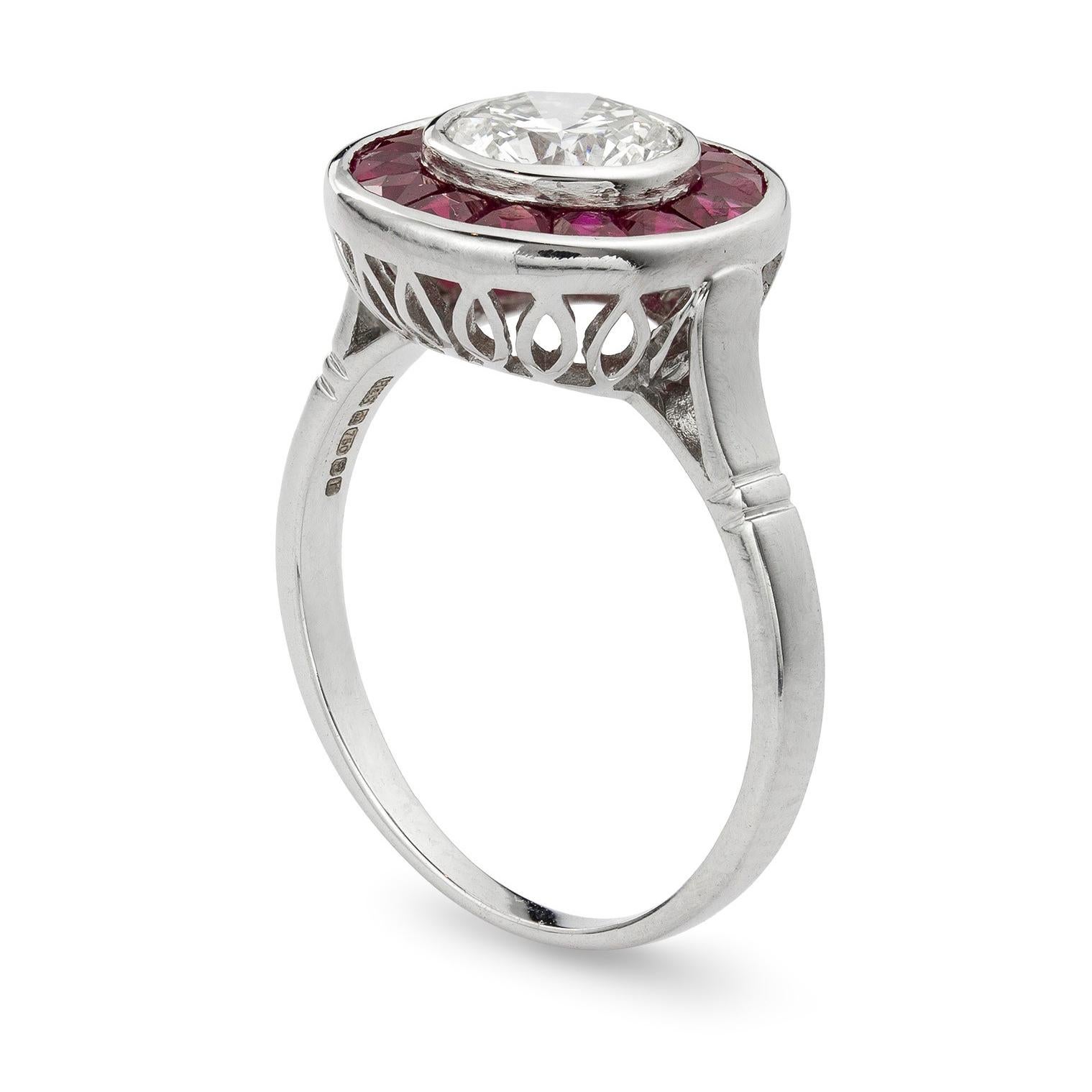 A diamond and ruby target ring, rubover-set to the centre with a round brilliant-cut diamond weighing 1.1 carats surrounded by calibre-cut rubies, all set in white gold, hallmarked 18ct gold, London, 2016, bearing the Bentley & Skinner sponsor mark,