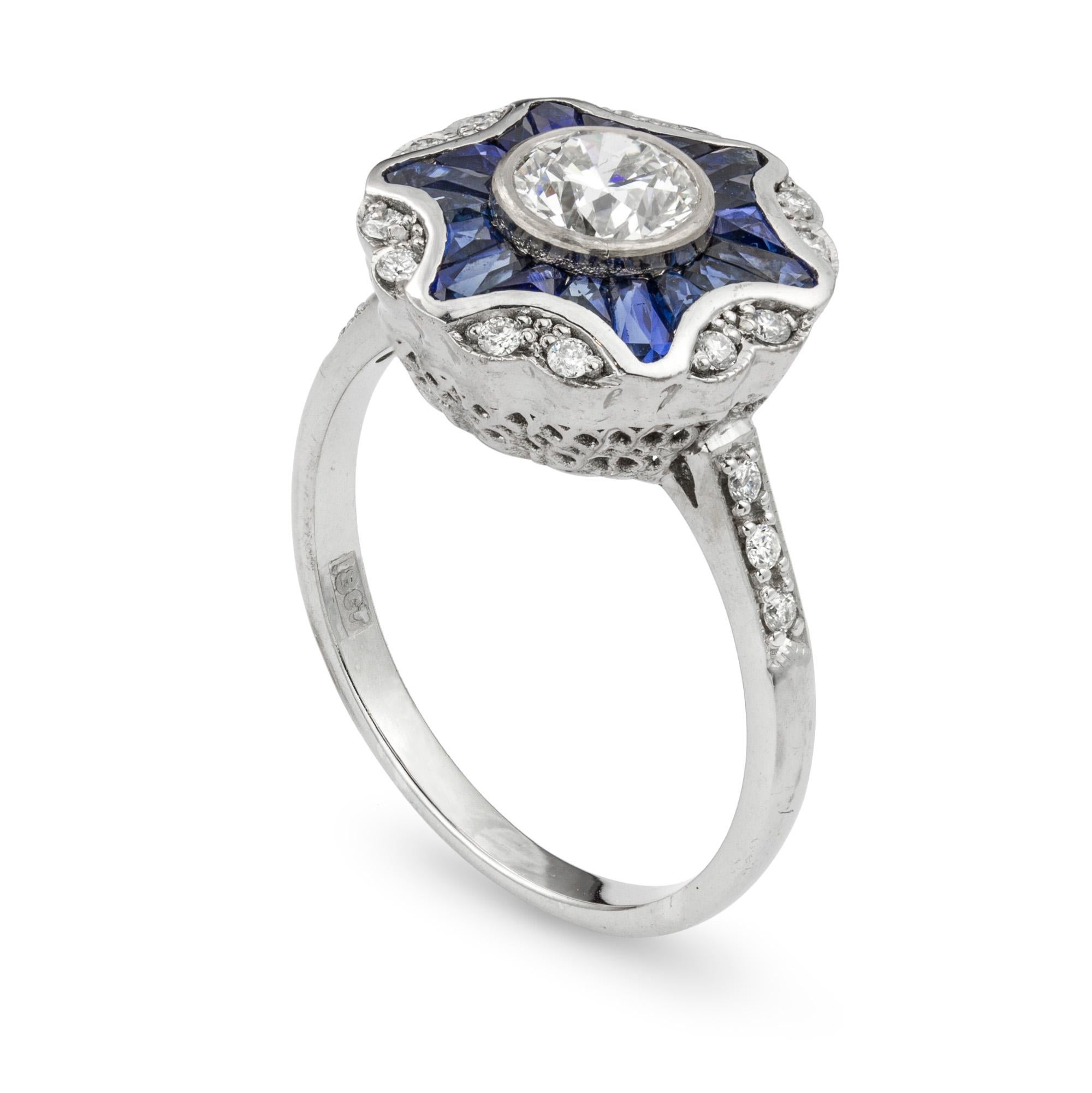 A diamond and sapphire ring, the centre brilliant-cut diamond accompanied by IGL Certificate stating the weight 0.70 carats of colour H and clarity VS2 surrounded by a star border of sapphires with a round border of diamonds to diamond-set