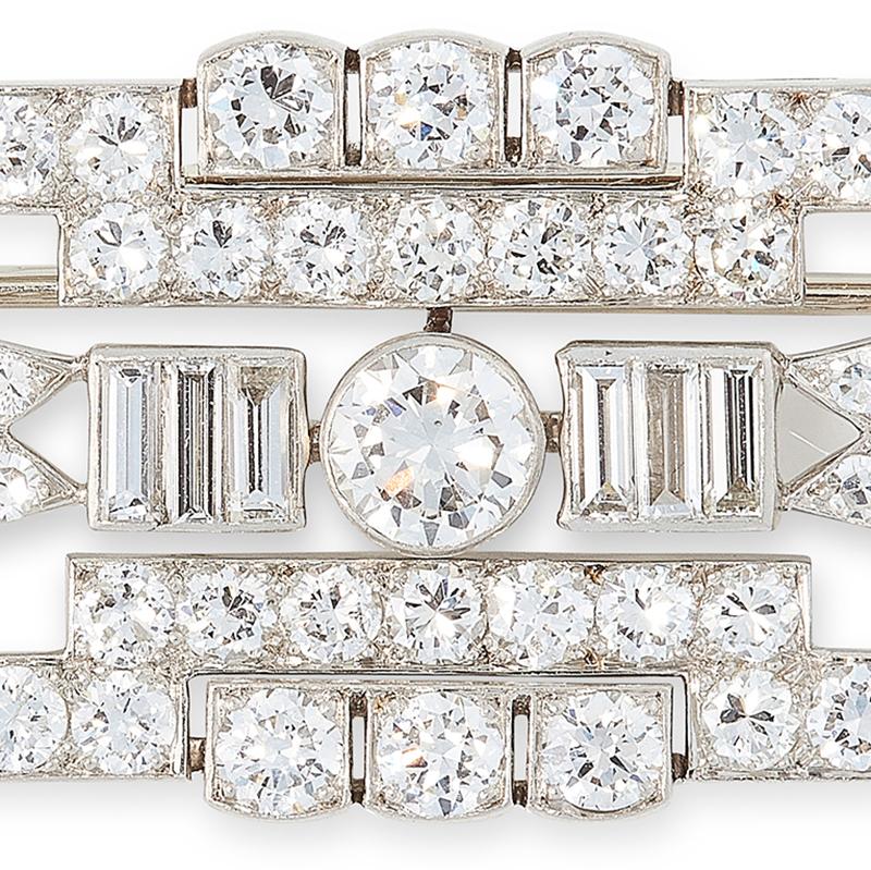A diamond brooch by Kochert, the openwork design set with a principal round cut diamond of 0.50 carats, flanked by baguette cut diamonds and within a surround of round and single cut diamonds, all totalling 5.0-6.0 carats, signed AK, Austrian assay