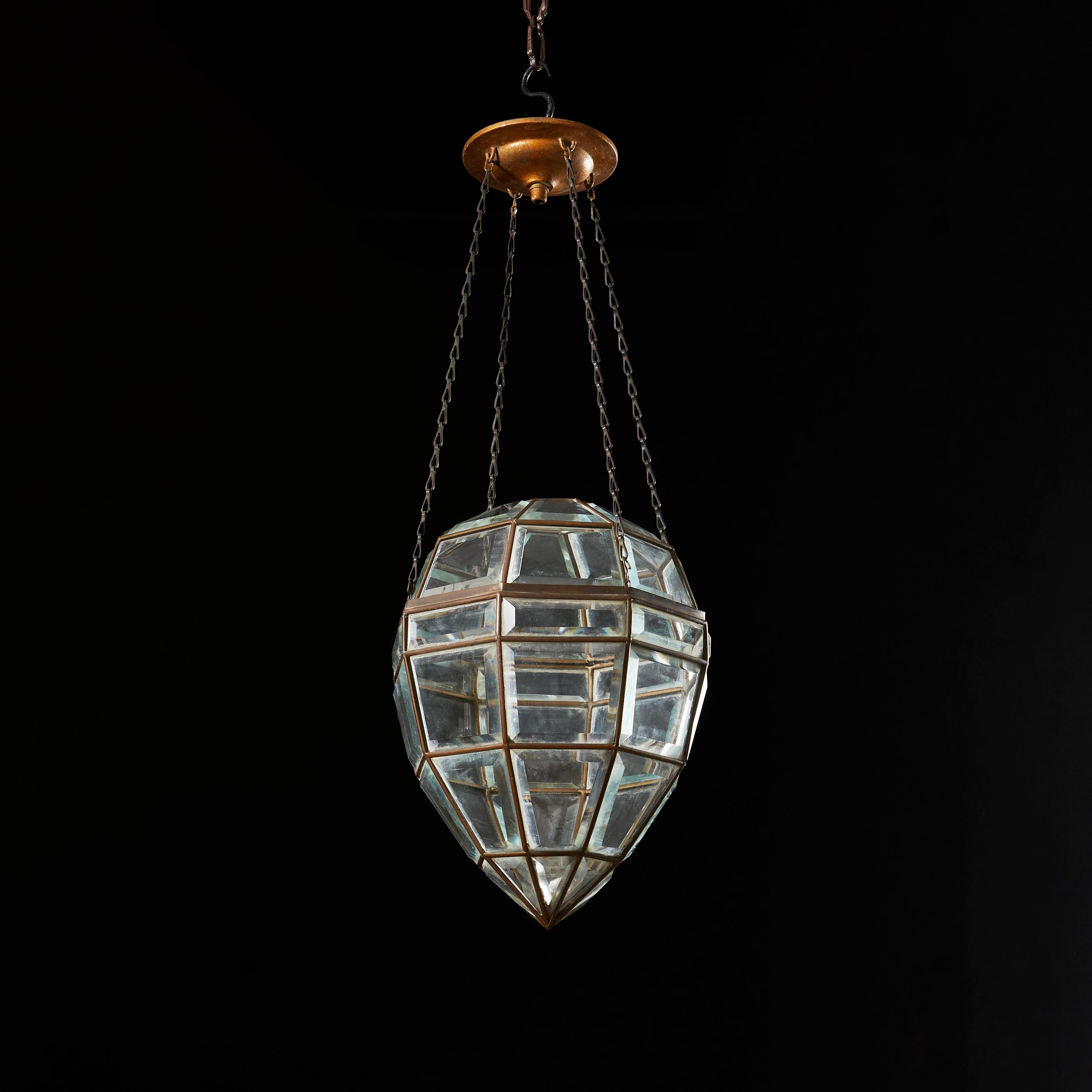An early twentieth century glass pendant light in the form of a cut diamond, each panel of glass with beveled edges, sitting within a leaded frame.

Currently wired for the UK.

Measures: Height of pendant 32.00cm
Overall height 60.00cm.