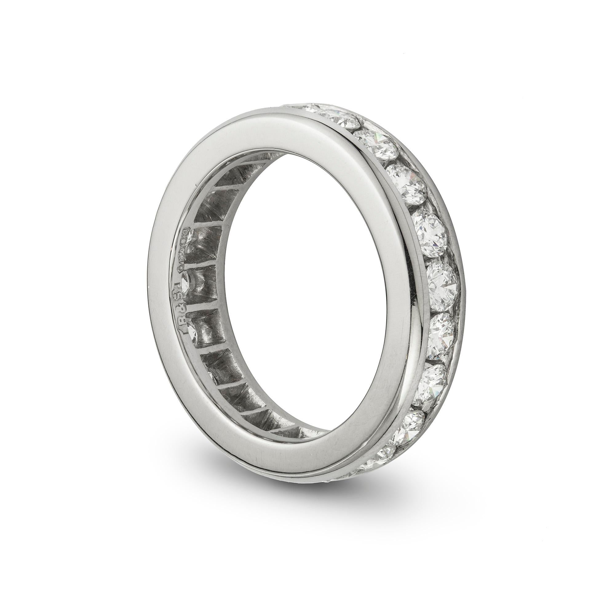 A diamond full eternity ring, with round brilliant-cut diamonds in a channel setting, all in platinum, estimated total diamond weight 2.10 carats,  hallmarked 950 platinum, London 2015, made by Bentley & Skinner, measuring approximately 4.5mm wise,