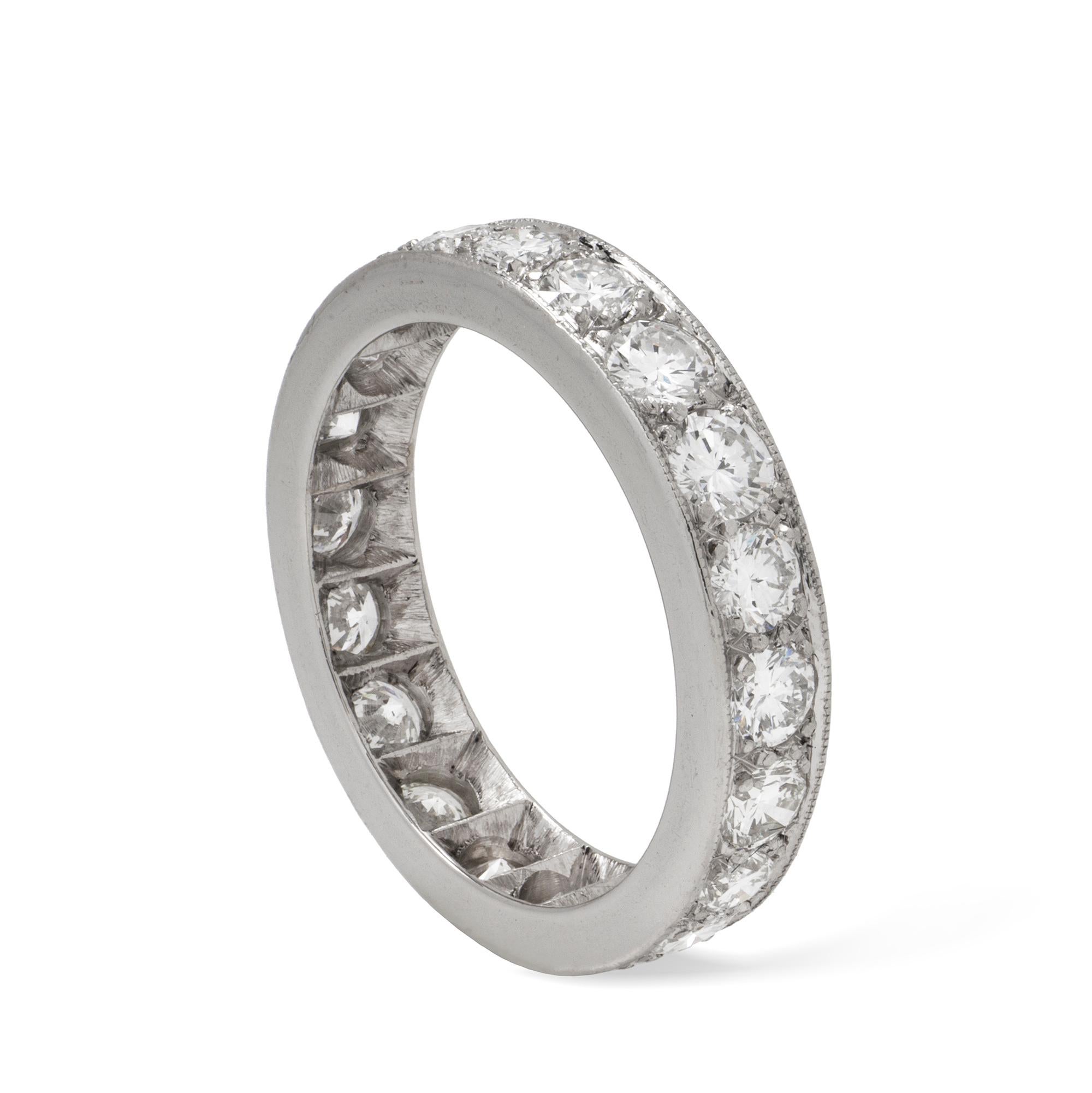 A diamond full eternity ring, consisting of twenty round brilliant-cut diamonds estimated to weigh 3 carats in total, all grain set in platinum mount, later hallmarked 950 platinum, London, bearing the Bentley & Skinner sponsor mark, measuring