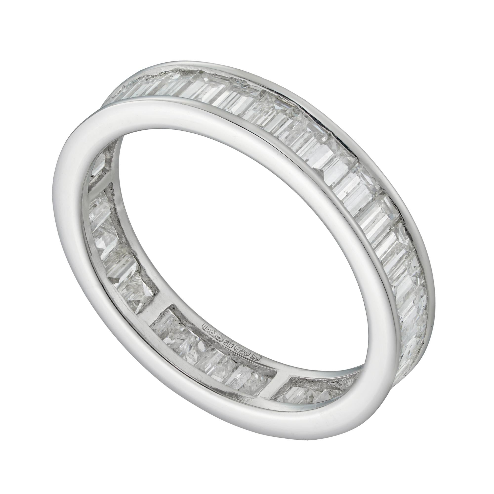 A diamond full eternity ring, the baguette-cut diamonds estimated to weigh 1¾ carats in total, assessed to be of G-H colour and SI-I clarity, all channel-set to a white gold mount, hallmarked 18ct, London, bearing the Bentley and Skinner sponsor