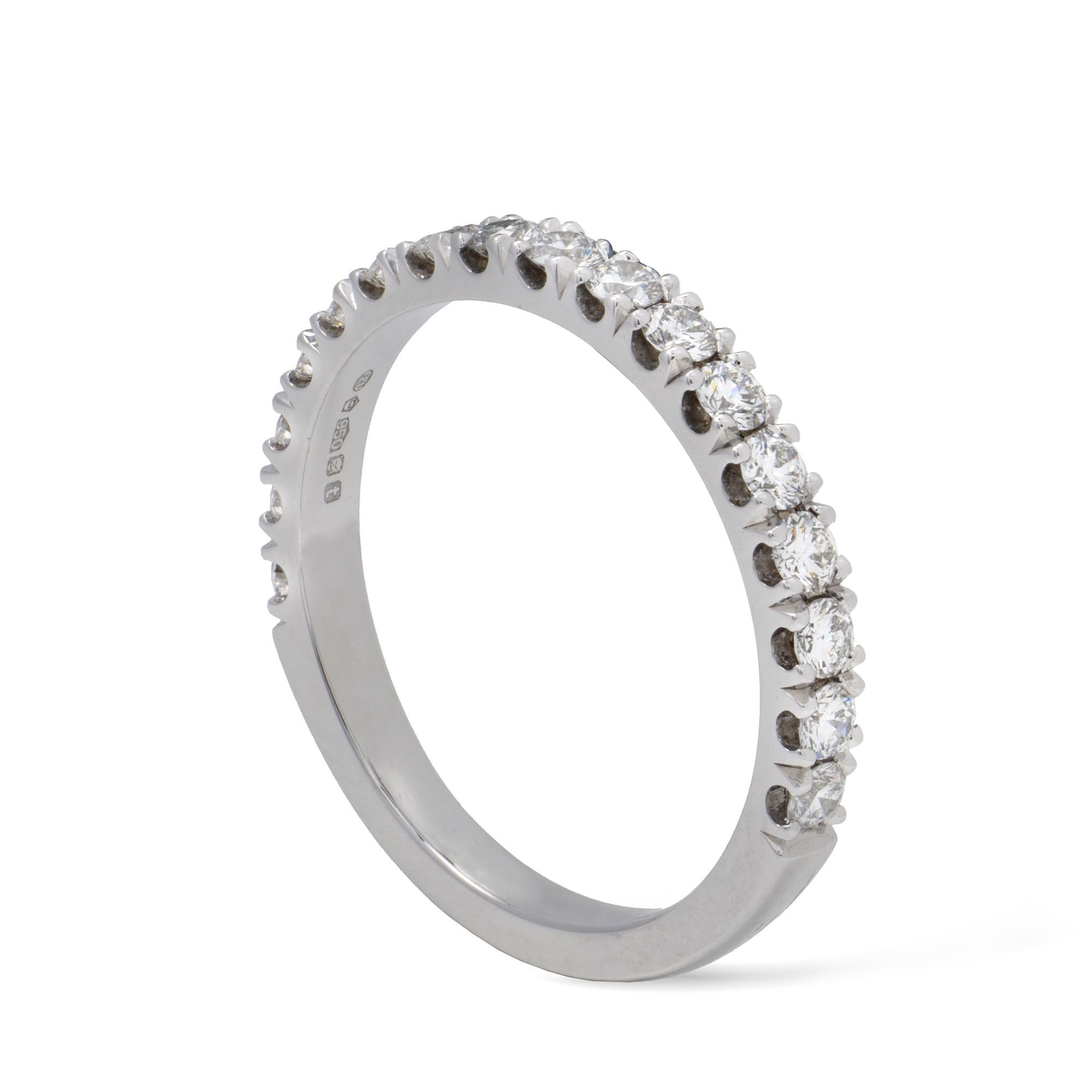 A diamond half eternity ring, the seventeen round brilliant-cut diamonds weighing 0.66 carats in total, claw-set in platinum mount, hallmarked 950, London 2018, the head measuring 21 x 2.6mm,  finger size O, gross weight 4.1 grams. 

This ring is in