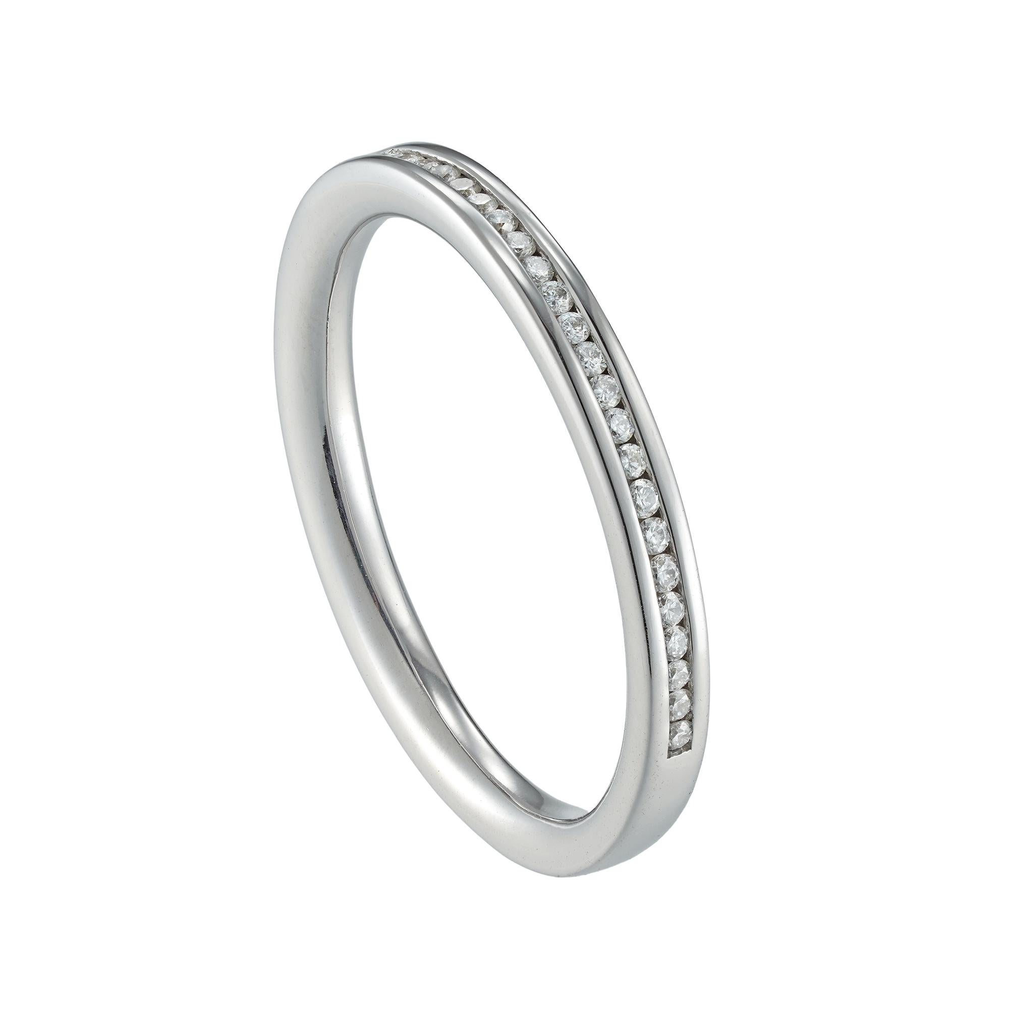 A diamond half eternity ring, consisting of thirty three round brilliant-cut diamonds weighing 0.2 carats in total, channel-set in white gold mount, hallmarked 18ct gold, Sheffield, measuring 2mm, wide, finger size L, gross weight 2.4 grams.

This