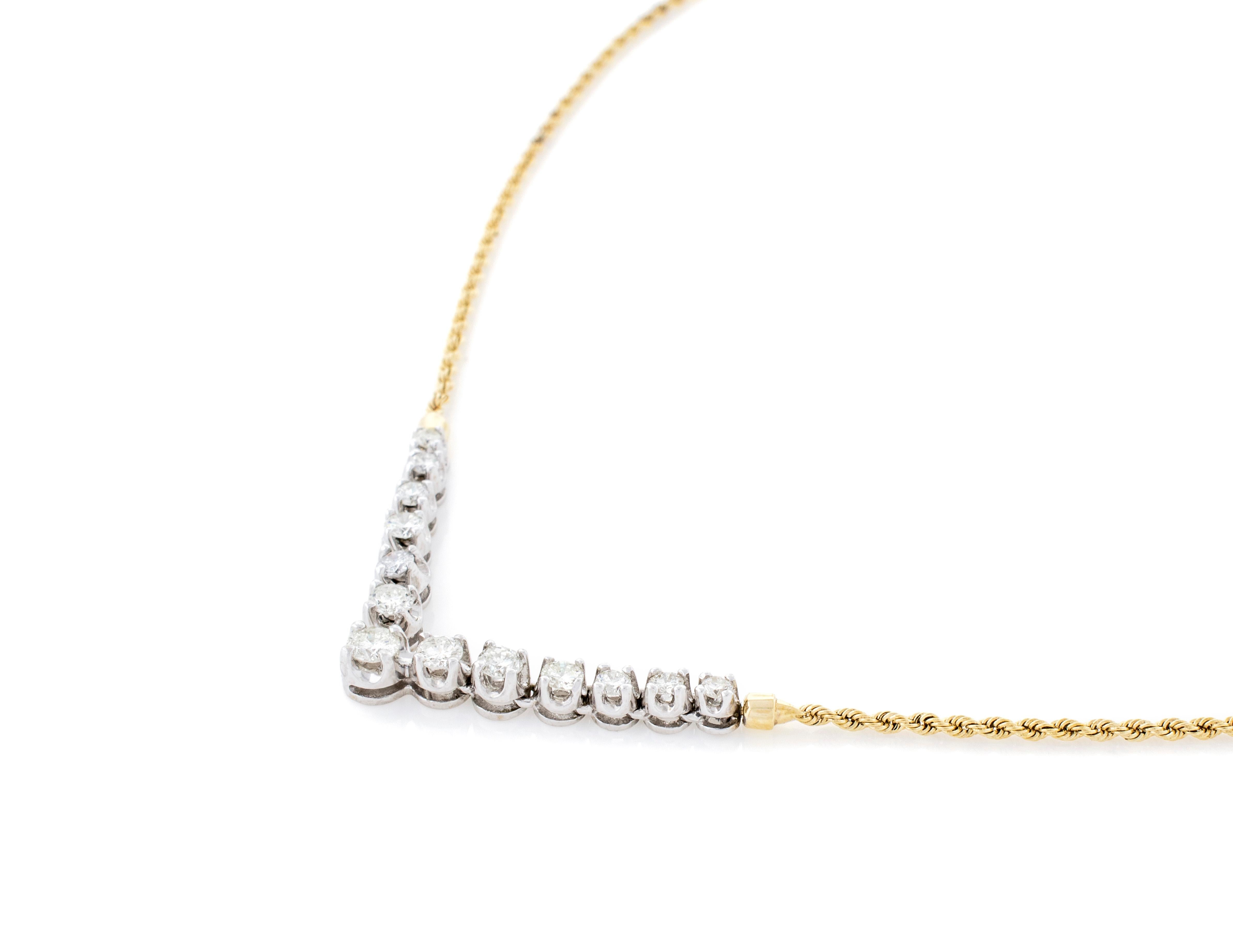 A Classic V shape Diamond Necklace made of 14 karat Yellow Gold and White Gold. Each Diamond is individually set in a 4-prong white gold setting that articulates (moves independently). There are 13 Round Brilliant Diamonds grading SI-2-3 Clarity,