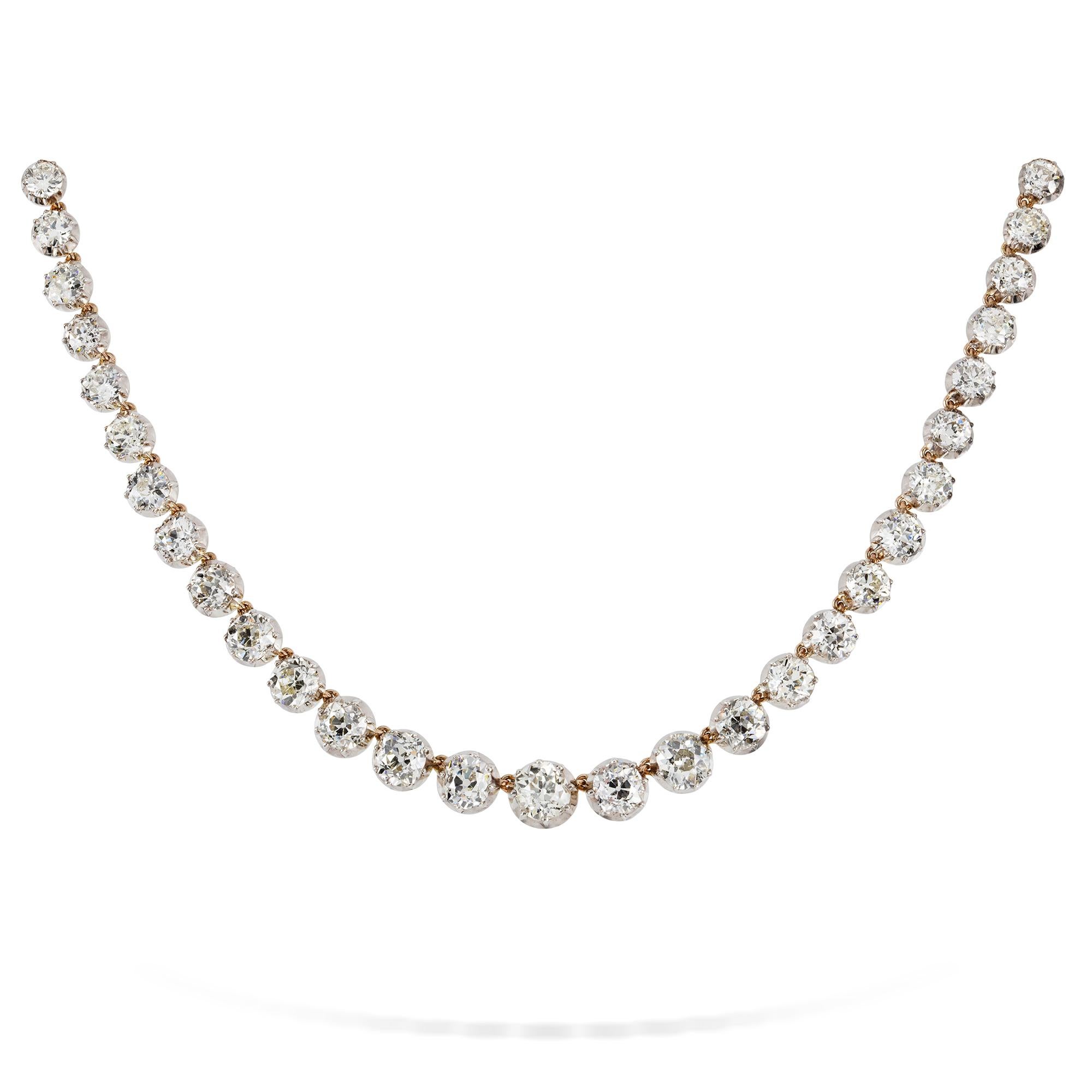 A diamond Riviere necklace, consisting of fifty-six graduated old brilliant-cut diamonds ranging from 0.3 to 2 carats, weighing a total of 34.5 carats, all cut-down set in silver to an 18ct yellow gold mount, with old brilliant-cut diamond-set clasp
