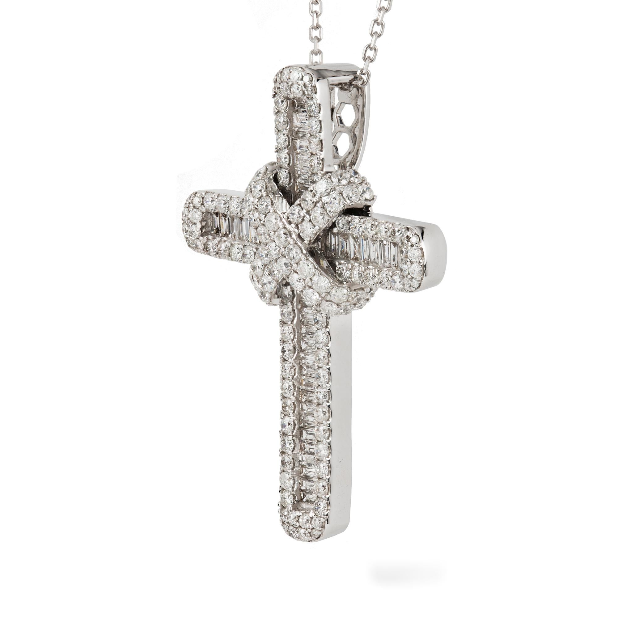 Un pendentif en forme de croix serti de diamants, la rangée centrale étant sertie de diamants baguettes, entourée de diamants ronds de taille brillant sertis en griffe, recouverts au centre de deux ceintures croisées,  les diamants sont estimés à un