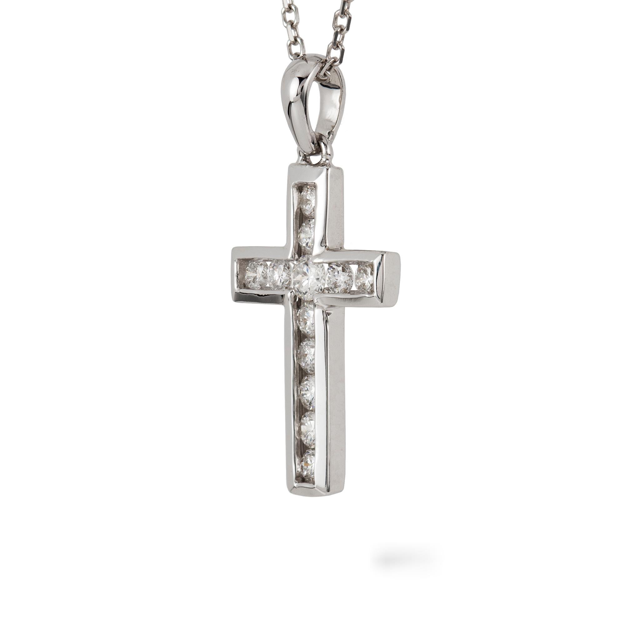 A diamond-set cross, the twelve round brilliant-cut diamonds estimated to weigh 0.5 carats, all channel-set in white gold mount with pendant loop, suspended by white gold trace chain, hallmarked 18ct gold, London 2019, the cross measuring