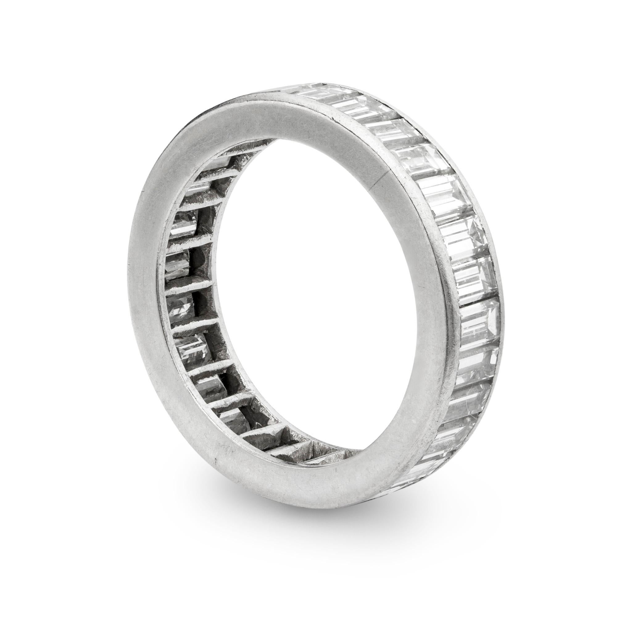 A diamond-set full eternity ring, the ring set throughout with emerald-cut diamonds, estimated to weigh a total of 3.20 carats, set in white mount, later hallmarked platinum, London 2016, bearing the Bentley & Skinner sponsormark, ring size M1/2,