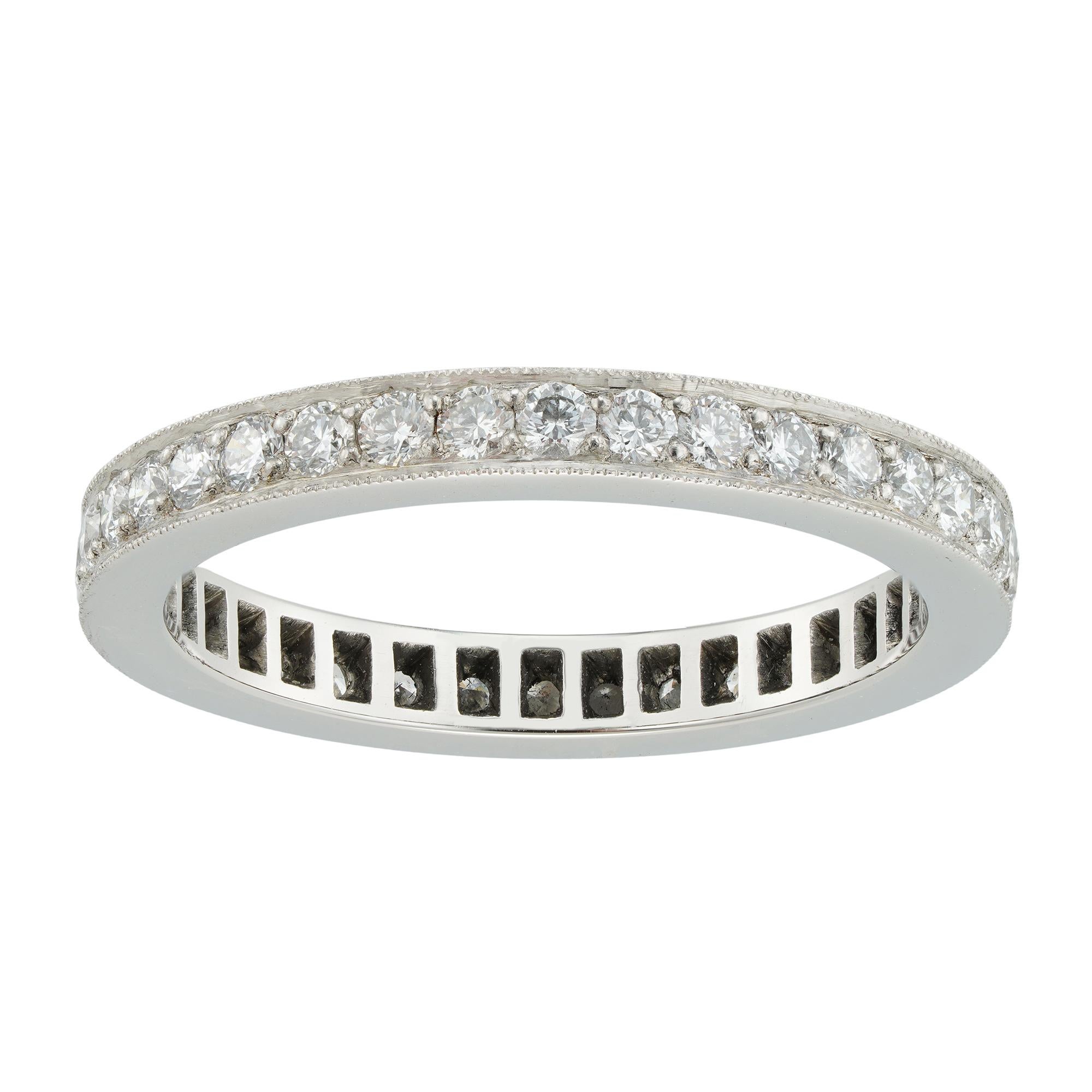 A diamond-set full eternity ring, the thirty-six round brilliant-cut diamonds weighing 0.75 carats in total, all mounted in platinum in a fine millegrain setting, hallmarked platinum 950, London, made by Bentley & Skinner, measuring 21 x 2.5mm,