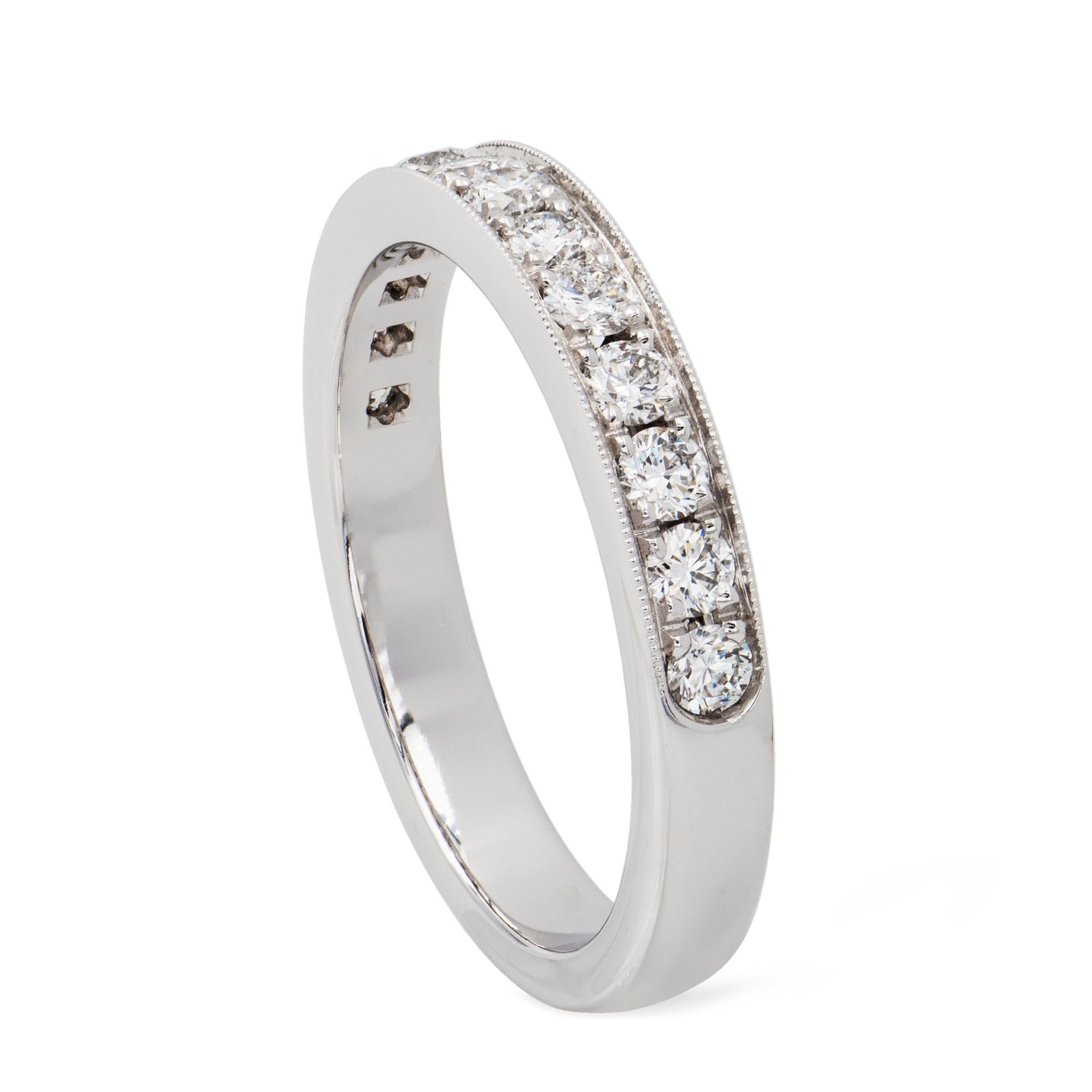 A diamond-set half eternity ring, set with thirteen round brilliant-cut diamonds weighing 0.57 carats in total, all grain-set in white gold mount with millegrain finials, hallmarked 18ct gold, London, bearing the Bentley & Skinner sponsormark,