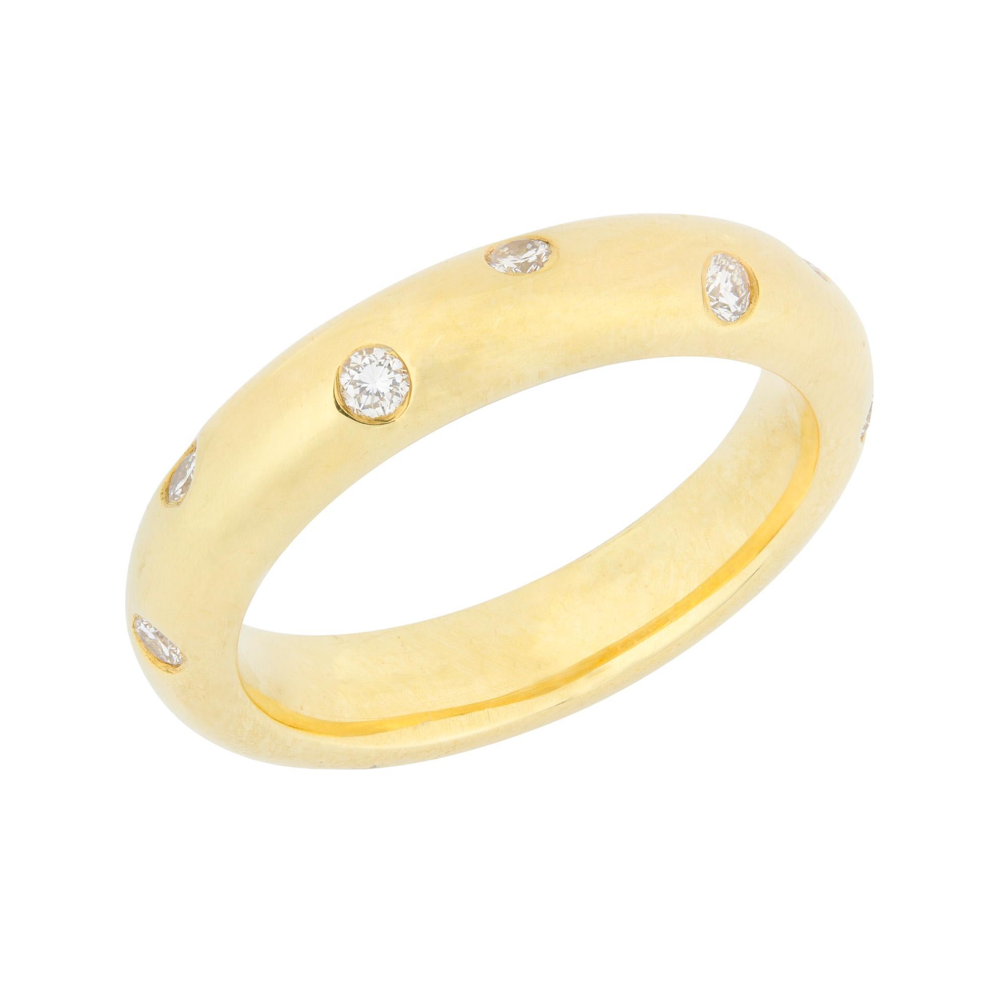 A diamond-set wedding band, the D-section yellow gold band measuring 4.1mm in width, set with twelve round brilliant-cut diamonds, hallmarked 18 carat gold, London 2001, bearing the LW&G sponsor mark, finger size M, gross weight 7.9 grams.

A