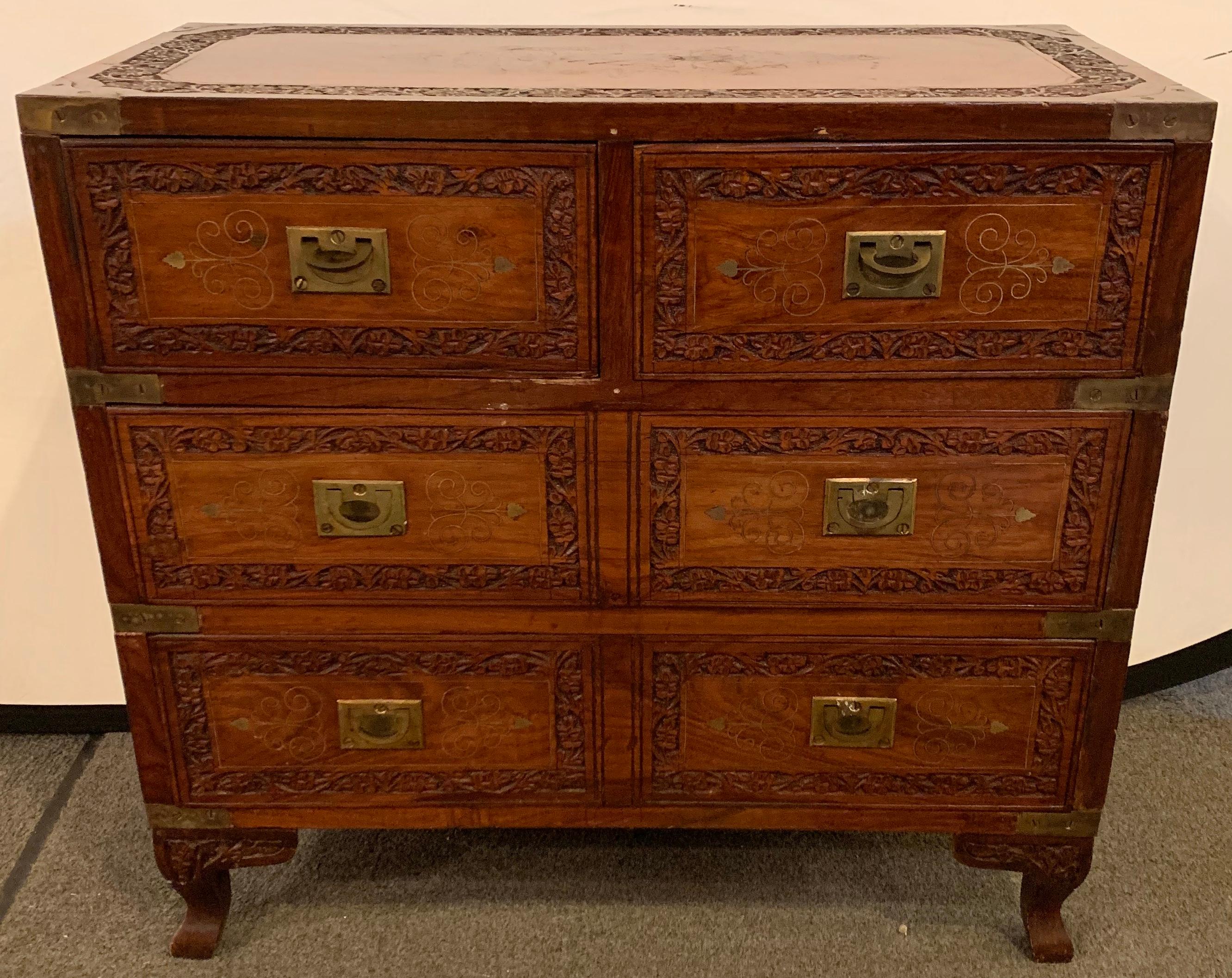A diminutive campaign chest or trunk having drawers and brass-boule inlays.
The chest features two over two drawer and brass floral design. The wood is hand carved beautiful and the details of the design makes this piece timeless and classy. It