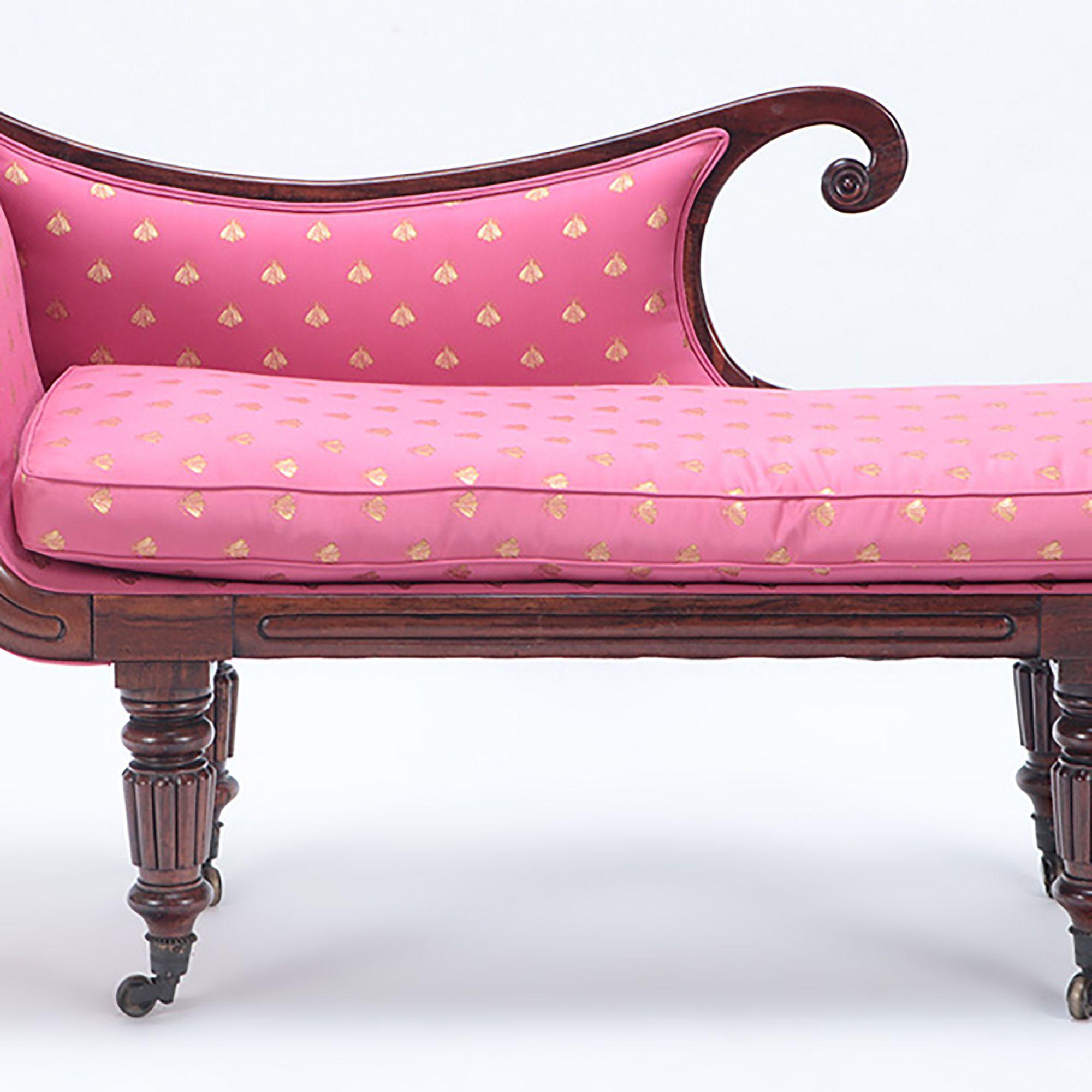 This outstanding form is a visual delight! With a typically shaped and scrolled back, upholstered back and cushion, resting on turned and fluted tapering legs terminating in casters. The smaller size makes it a versatile decorative piece to use