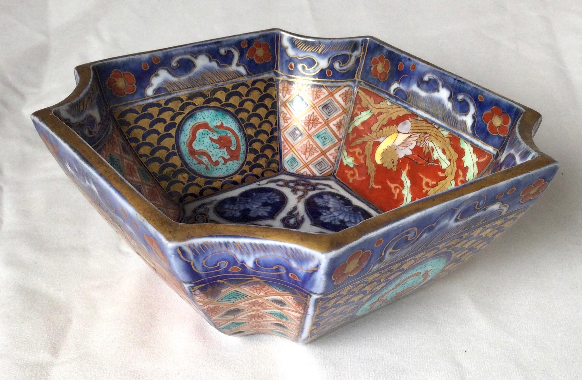 A beautifully painted Imari bowl in classic iron red and cobalt blue on white porcelain background with gilt highlights all over. 6.25 inches by 6.25 inches.