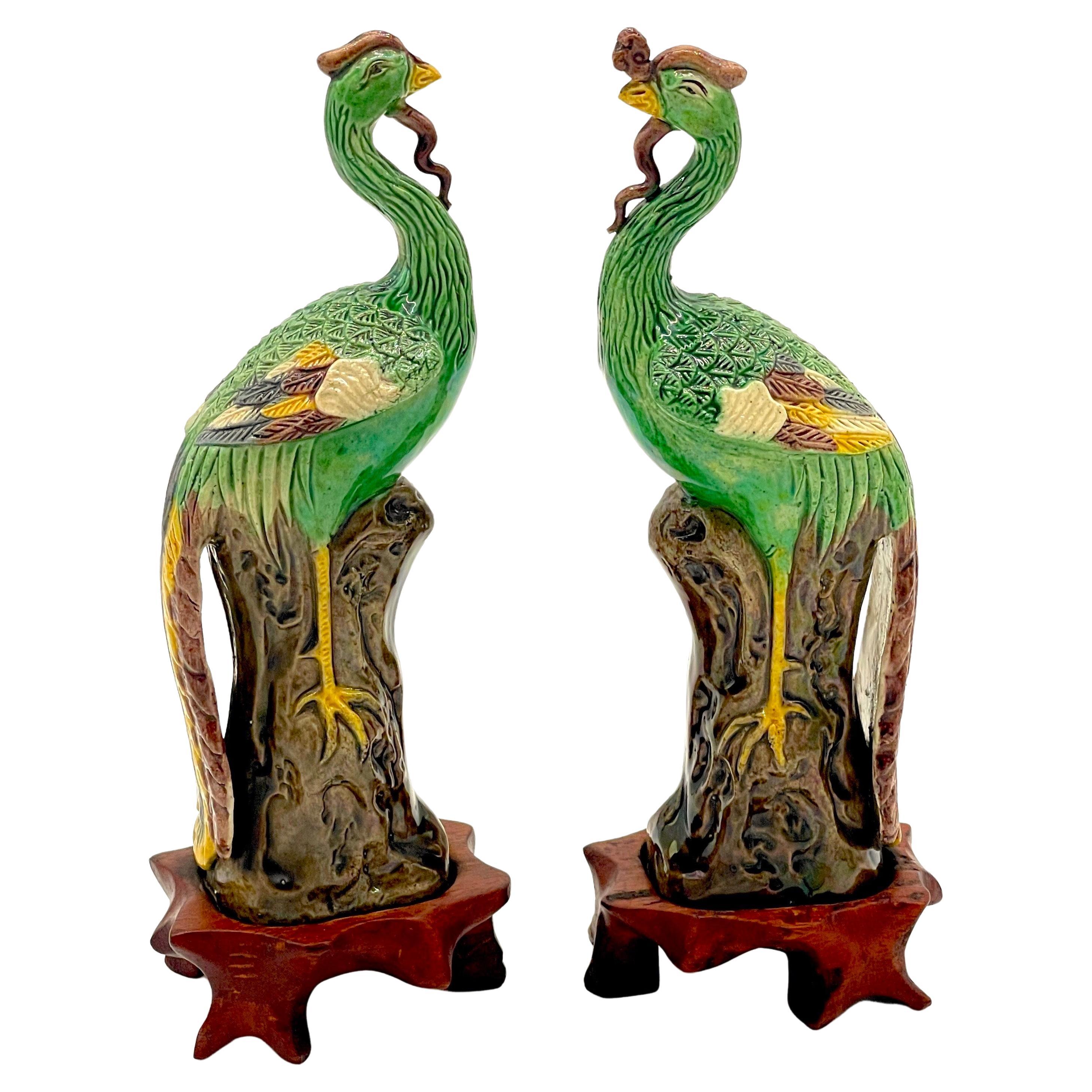 A Diminutive Pair of Chinese Sancai Glazed Phoenix Birds, on Hardwood Stands 