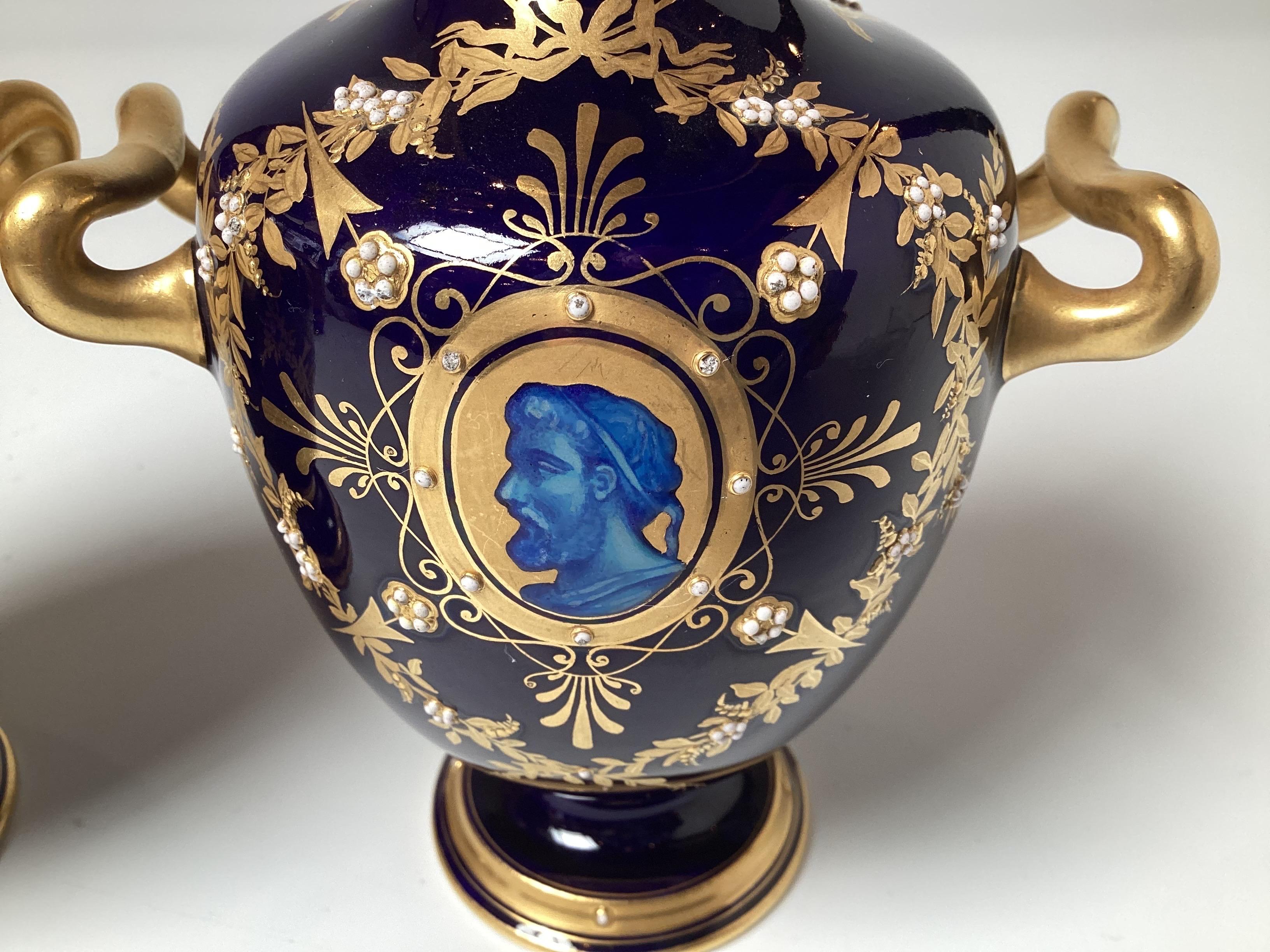 Classic pair of mid 19th Century Cobalt blue and gold portrait cabinet vases. The deep cobalt blue background with azure blue portrait profiles with hand gilt decoration. The gilt work with white beaded flower accents. 6.5 inches tall, attributed to