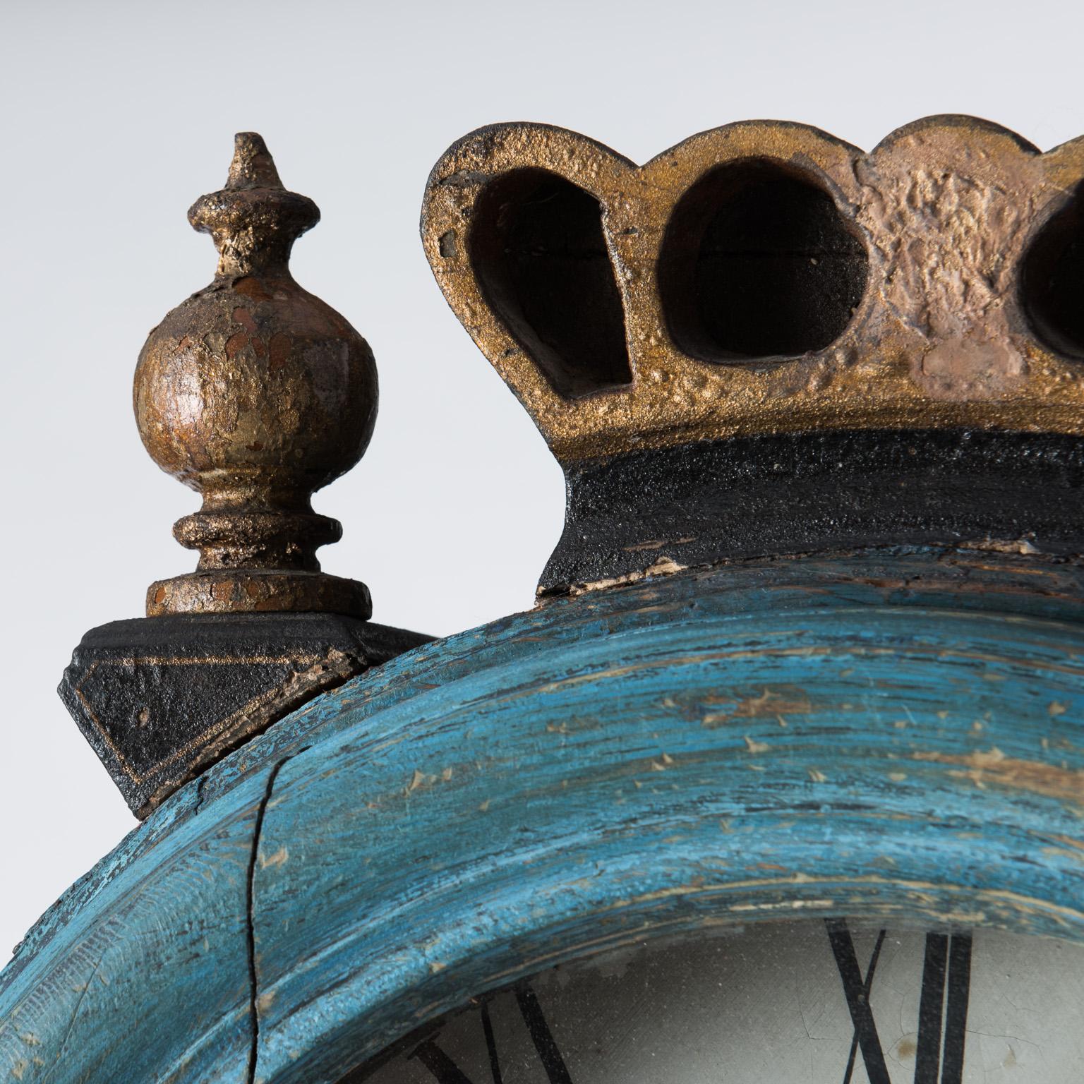 This charming clock must have been a custom order for a special person, with a specific design and size in mind. Every element is totally unique, from the winding key that also locks the door, to the fanciful crown surrounded by two gilded finials.