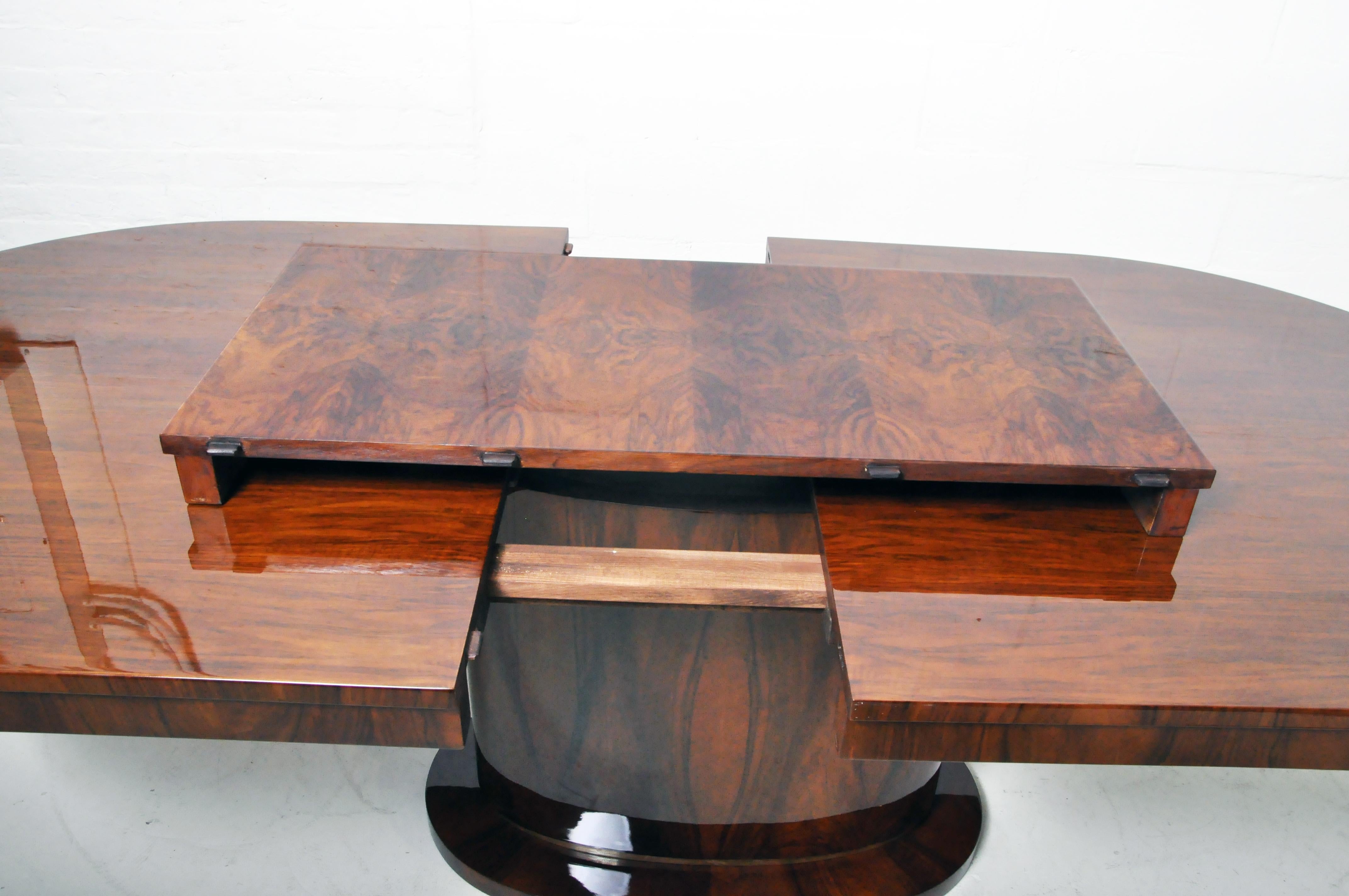 Dining Table with Walnut Veneer and a Brass Foot 2