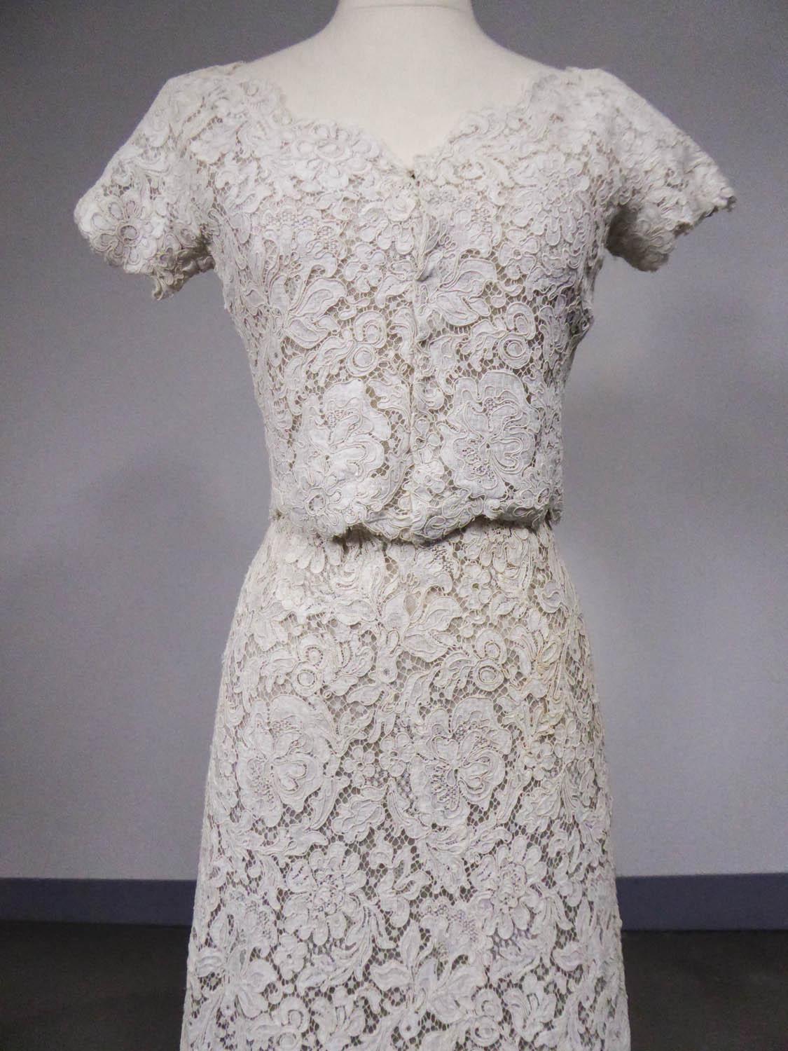 Circa 1965
France

Bolero and dress set in guipure and cream lace with floral pattern by Christian Dior dating from 1960/1965. Fitted bustier in cream tulle with high waist and thin straps fully lined with matching tulle and muslin. Flared skirt