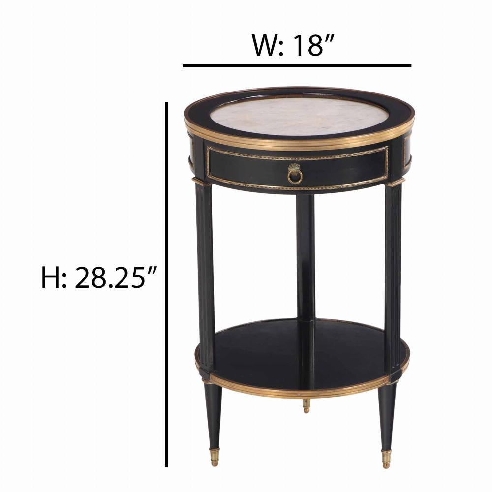 The round top with inset marble, over a gold banded edge with a single drawer, supported by by three round, tapering legs joined by a banded lower shelf and terminating in bronze caps. Perfect for a plant or your cocktails! Found in Argentina.
