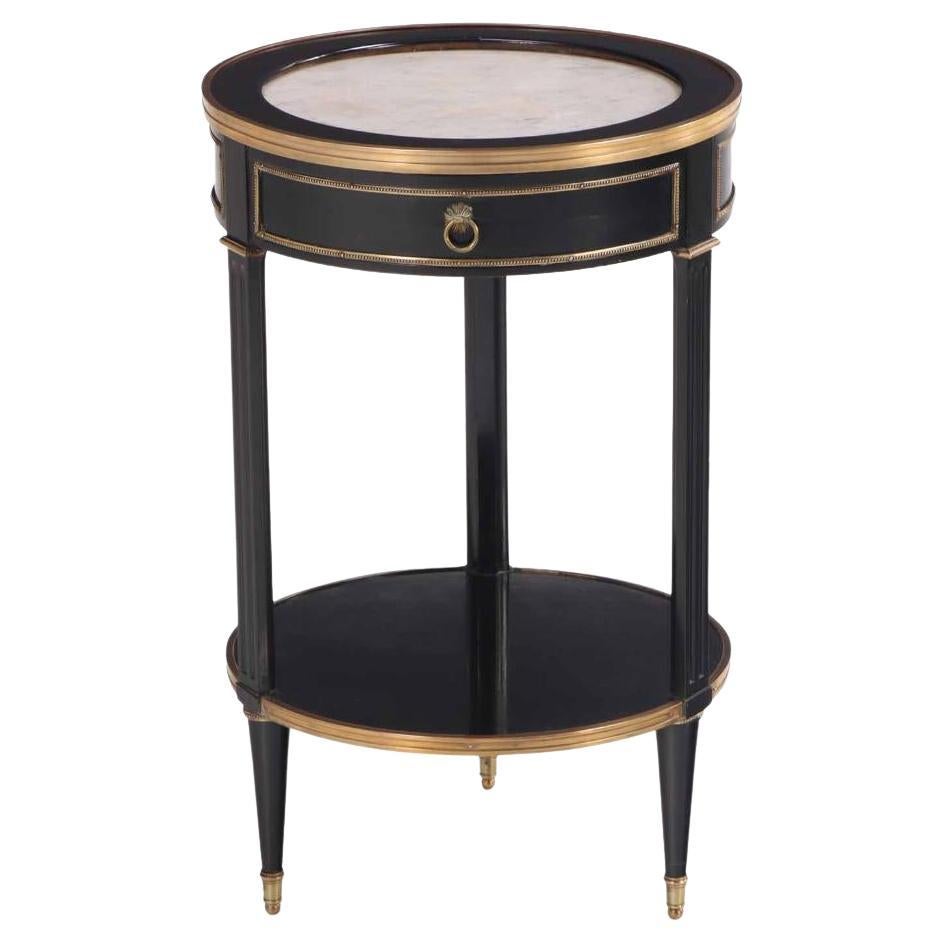 A Directoire style ebonized and bronze mounted marble top table, C. 1940. For Sale