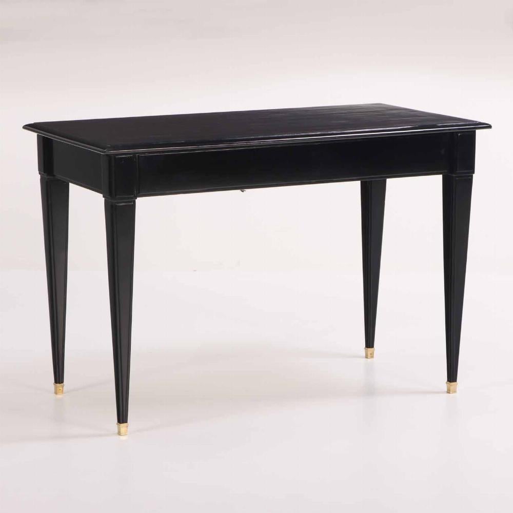 In the manner of late 18th-century French design, this elegant and finely proportioned desk exemplifies the neoclassical restraint and symmetry characteristic of the late 18th-century French aesthetic. Crafted in ebonized mahogany, the desk features