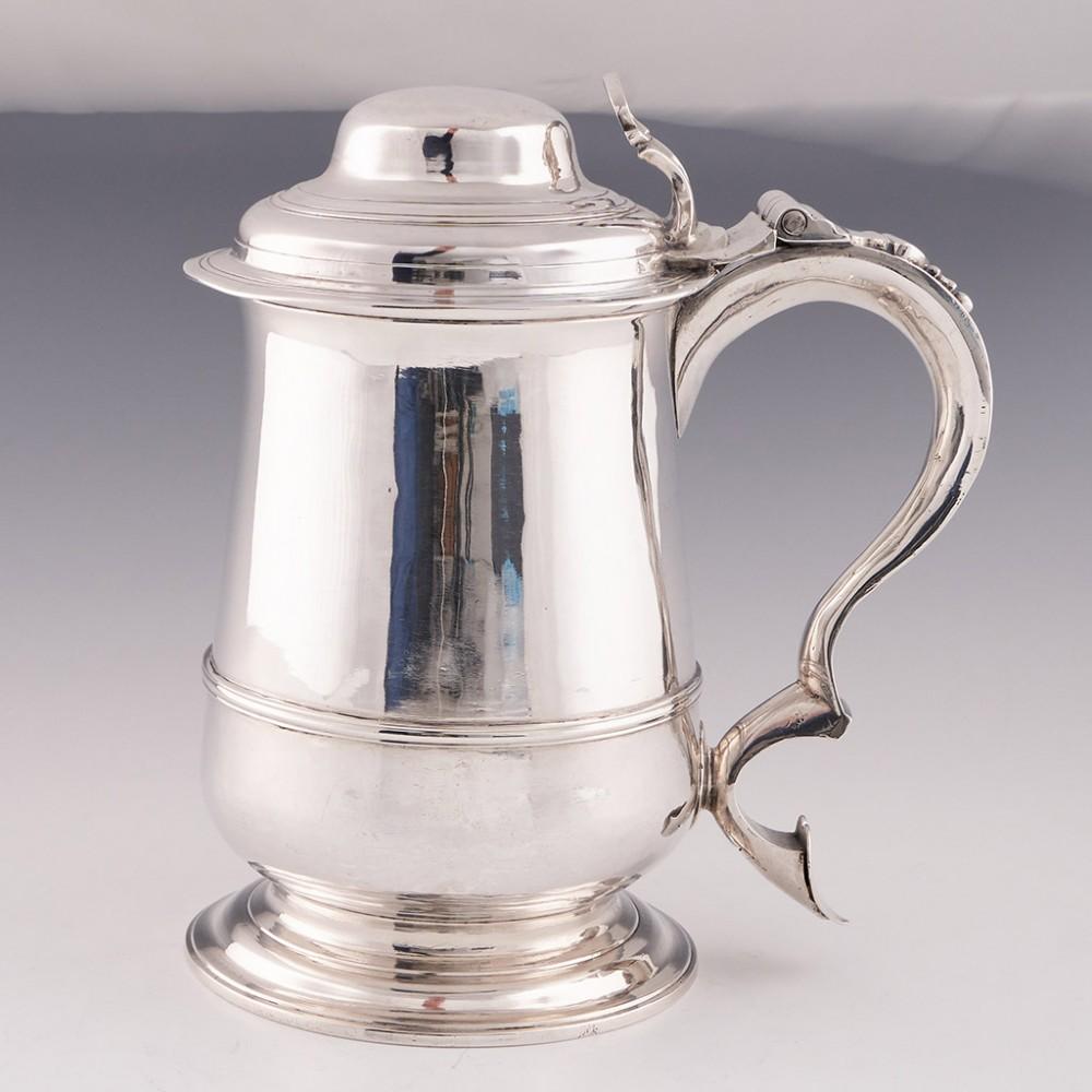A Domed Lid Sterling Silver Quart Tankard London, 1771

Additional information:
Date : Hallmarked in London 1771 For John King
Period : George III
Origin : London England
Decoration : Pierced thumbpiece. Reeded girdle and terraced pedestal foot
Size