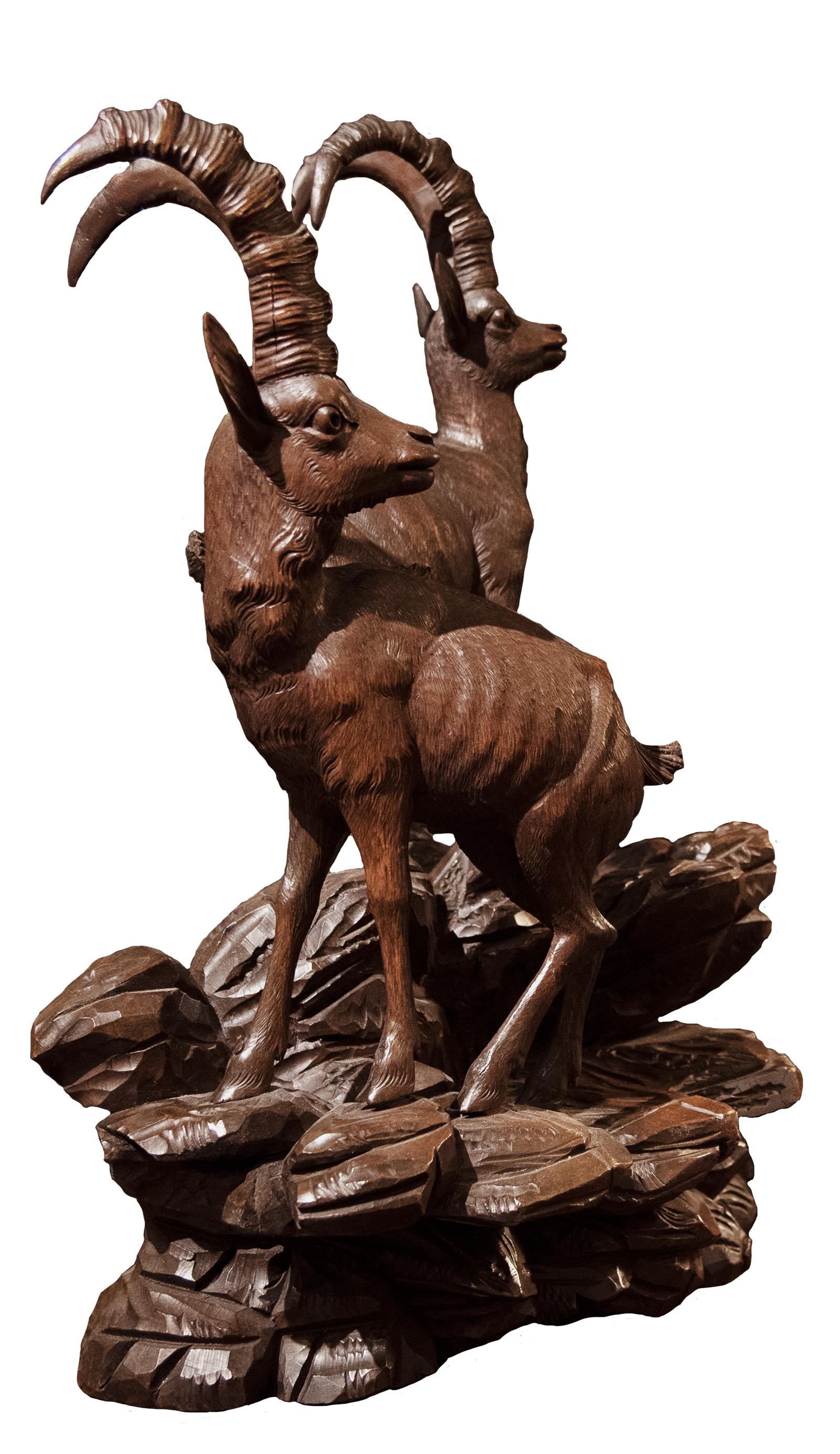 A 19th century Swiss wood sculpture of two ibexes.

Carved in the Black Forest style, popular in the late 19th century.