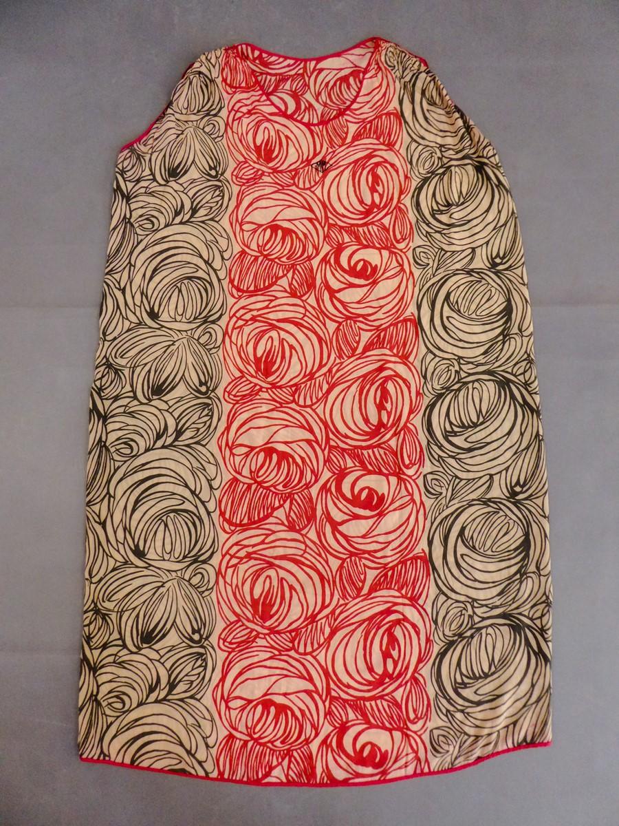 France-Paris
Circa 1915

A sleeveless and straight Sac day dress designed by Raoul Dufy for the Atelier Martine. Cream pongee silk printed with stylized generous roses alternately in red and black. Small embroidered diamond shape on the chest signed