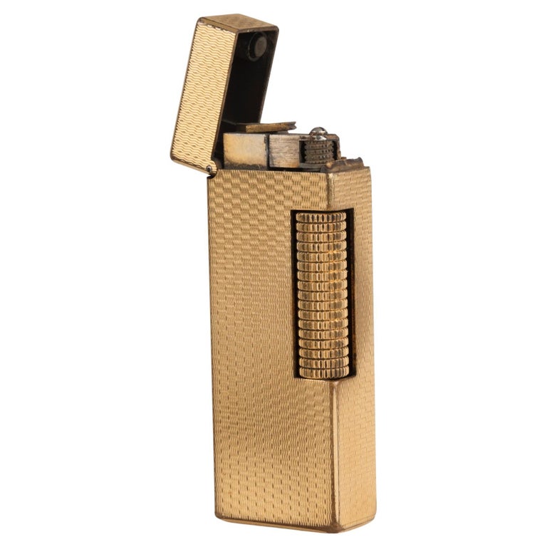 A Dunhill gold-plated cigarette lighter at 1stDibs