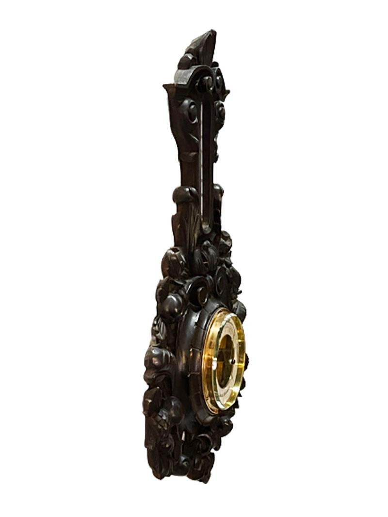 A Dutch carved wooden barometer with copper and facet cut glass housing. 
The carved wood has a scene of fruits and scrolls

A barometer is a scientific instrument used to measure air pressure in a particular environment. 
Pressure trend can