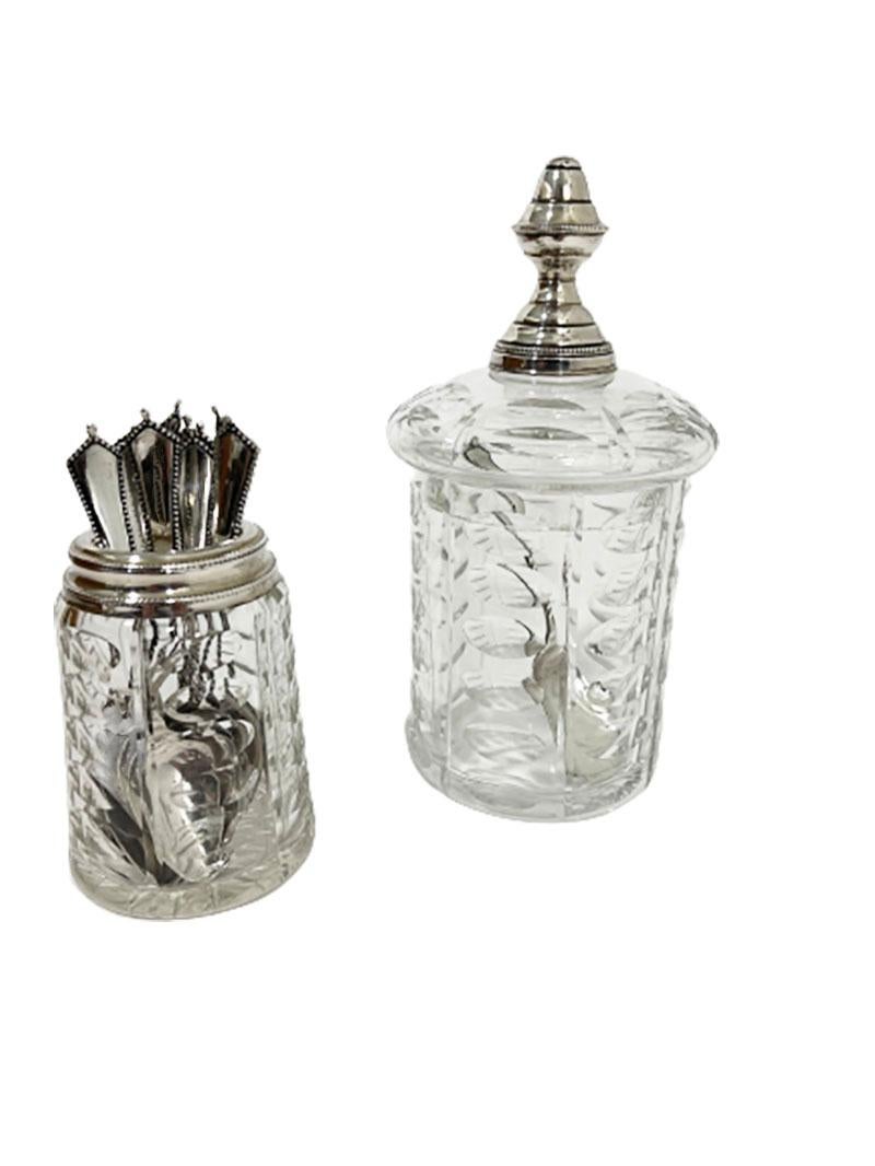 A Dutch 19th Century crystal and silver sugar bowl and a spoon vase set.

A crystal lidded sugar bowl with a silver knob. The crystal with olive cut and the lid with a silver knob, made by Jan Blom, Amsterdam (worked during 1875-1884). The silver