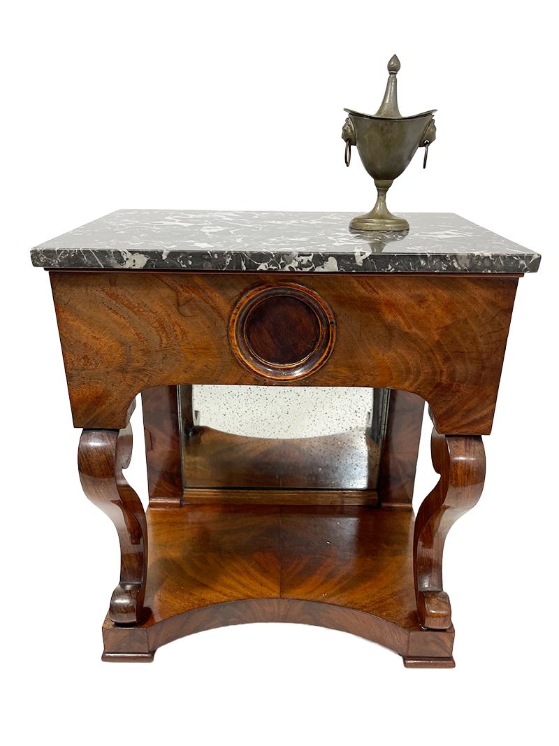 A Dutch 19th Century Miniature Console table

A 19th Century Dutch console table of 38 cm high with marble top, which is loose on the table. With an antique mirror and curled legs. An antique miniature pewter chestnut pot with lion heads and