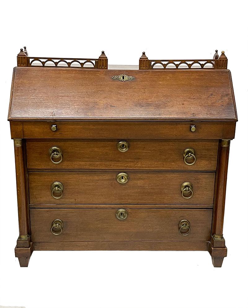 A Dutch 19th century oak secretaire

A Dutch 19th century oak secretaire and a wooden balcony rack. 
The secretaire consists of various drawers between 2 columns and a hidden drawer. 
The drawers have copper fittings. 2 keys present
Date