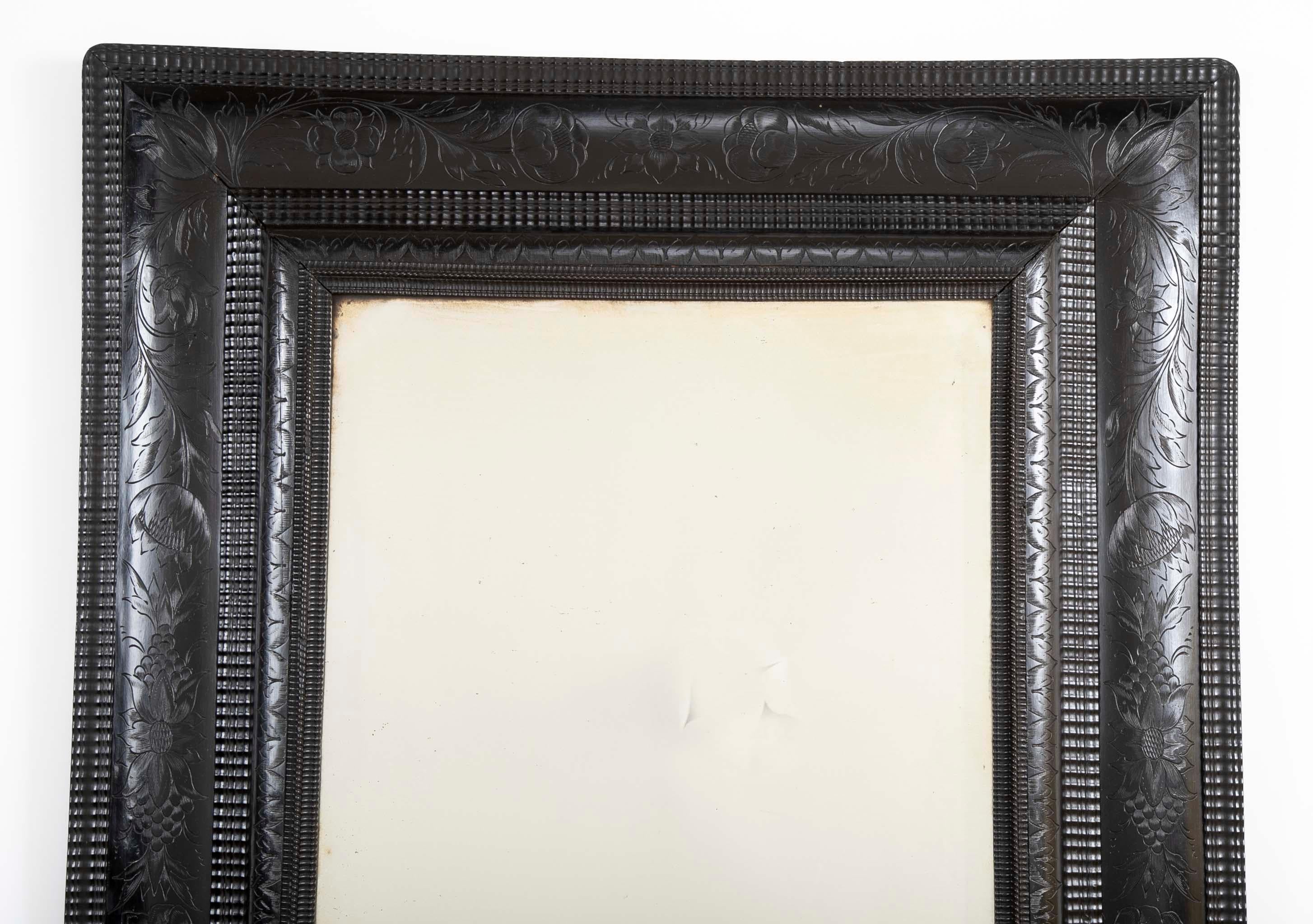 The perfect Gothic accent! An Ebonized mirror with incised floral motifs, Dutch, circa 1750.