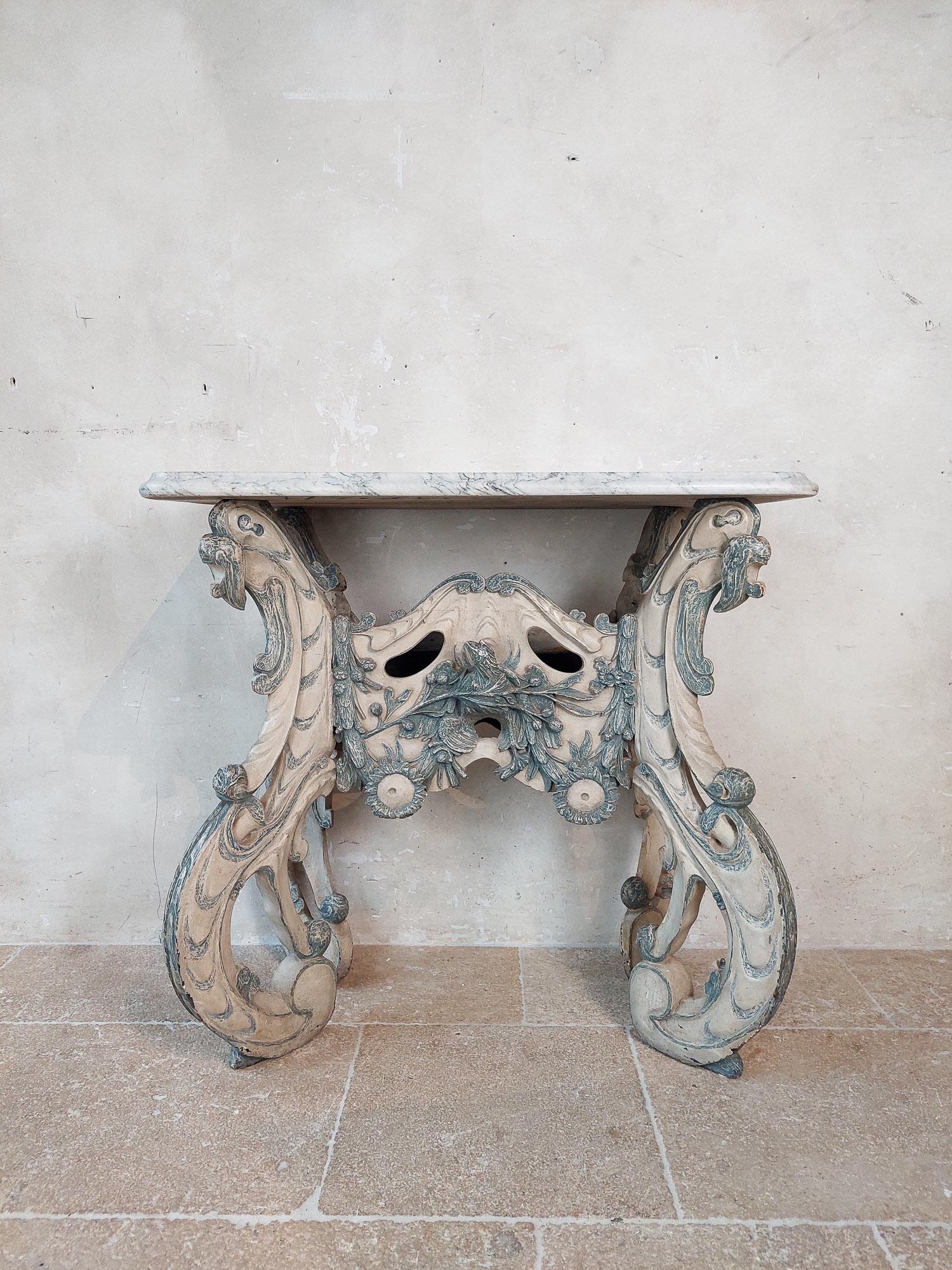 A Dutch carved blue and white painted limewood ‘kwab’ console or side table. Northern Netherlands, circa third quarter 17th century.

Console table with oblong white veined marble table top, on four S-curved feet, all carved with organic