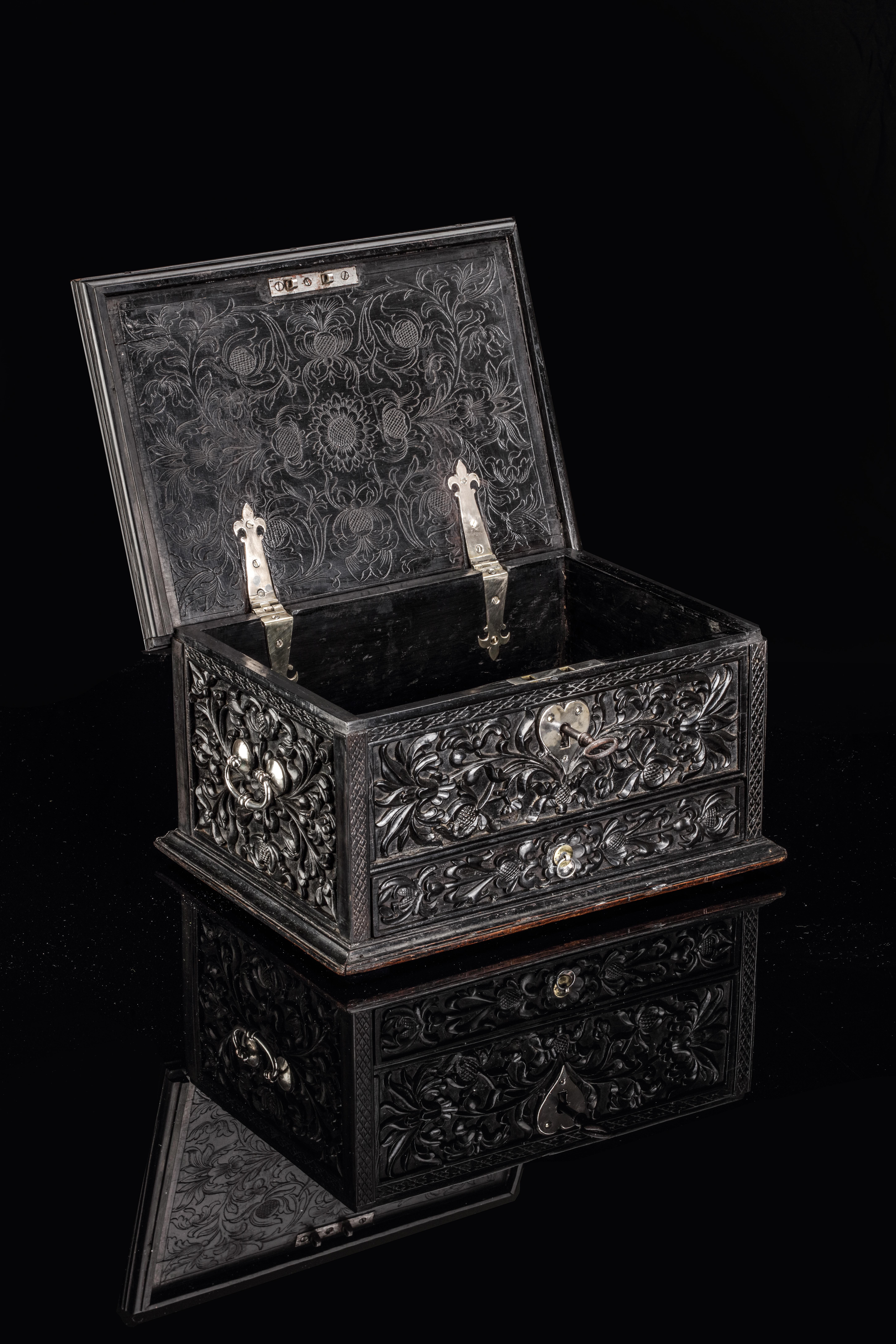 Batavia (Jakarta), or Sri Lanka, circa 1680-1720

The document or money box is densely carved with fine scrolling vines and lotus flowers. It has a charming heart- shapes silver lock-plate and compartments inside.

H. 18 x W. 31.5 x D. 23