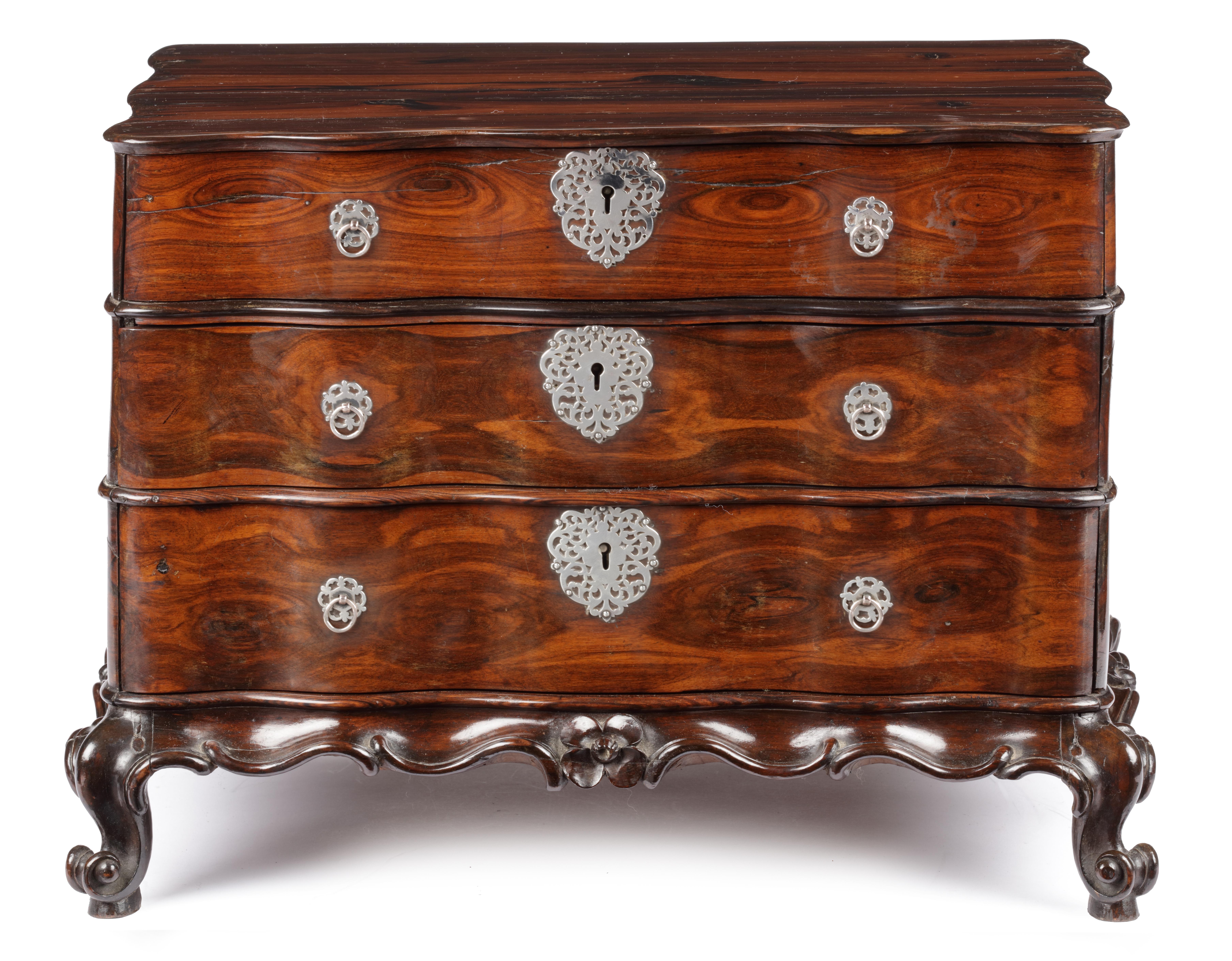 A Dutch-colonial Sri Lankan coromandel wood miniature chest of drawers with silver mounts

Sri Lanka, 18th century, circa 1750
 
H. 35 x W. 48 x D. 32 cm

Apart from being a highly decorative object and a status symbol, these miniature pieces of