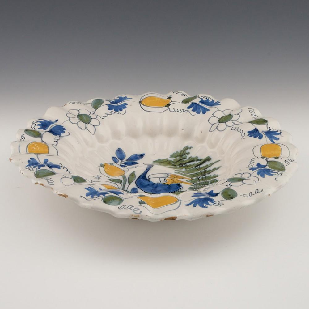 A Dutch Delft Lobed Dish, Late 17th Century

Eric Knowles Comments. Despite the flake chip this dish is a remarkable survivor, they are almost invariably cracked and severely chipped. The yellow enamel was the nearest at the time of manufacture that