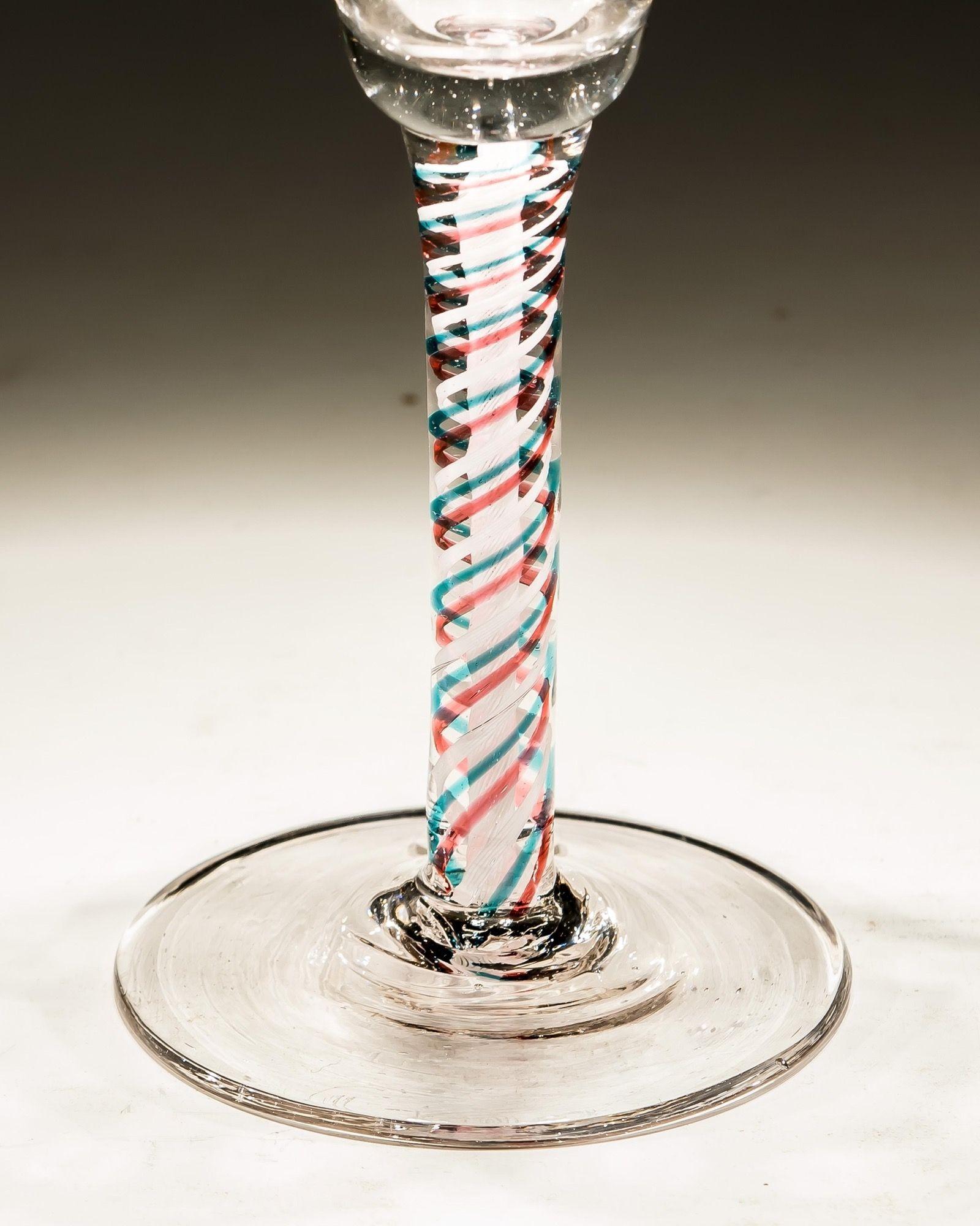 A Dutch colour twist containing white, red and blue with trumpet shaped bowl, engraved with stars and fruiting vine.